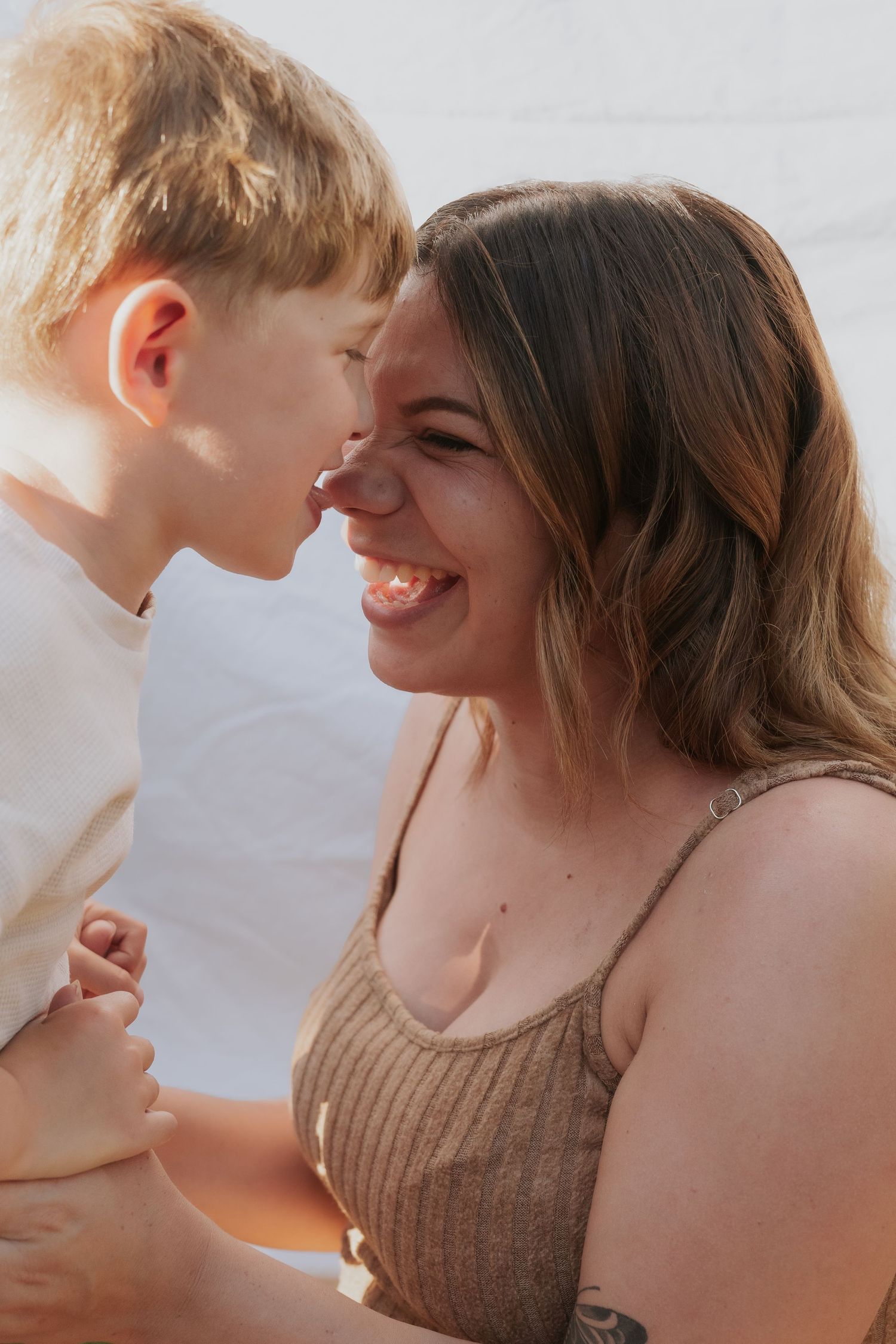 A series of tender moments captured between a parent and child in warm lighting.
