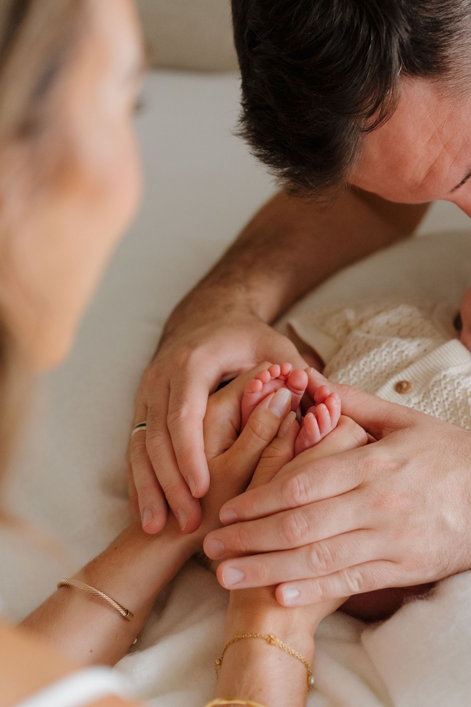 Close-up shot of hands gently intertwined showing intimate connection.