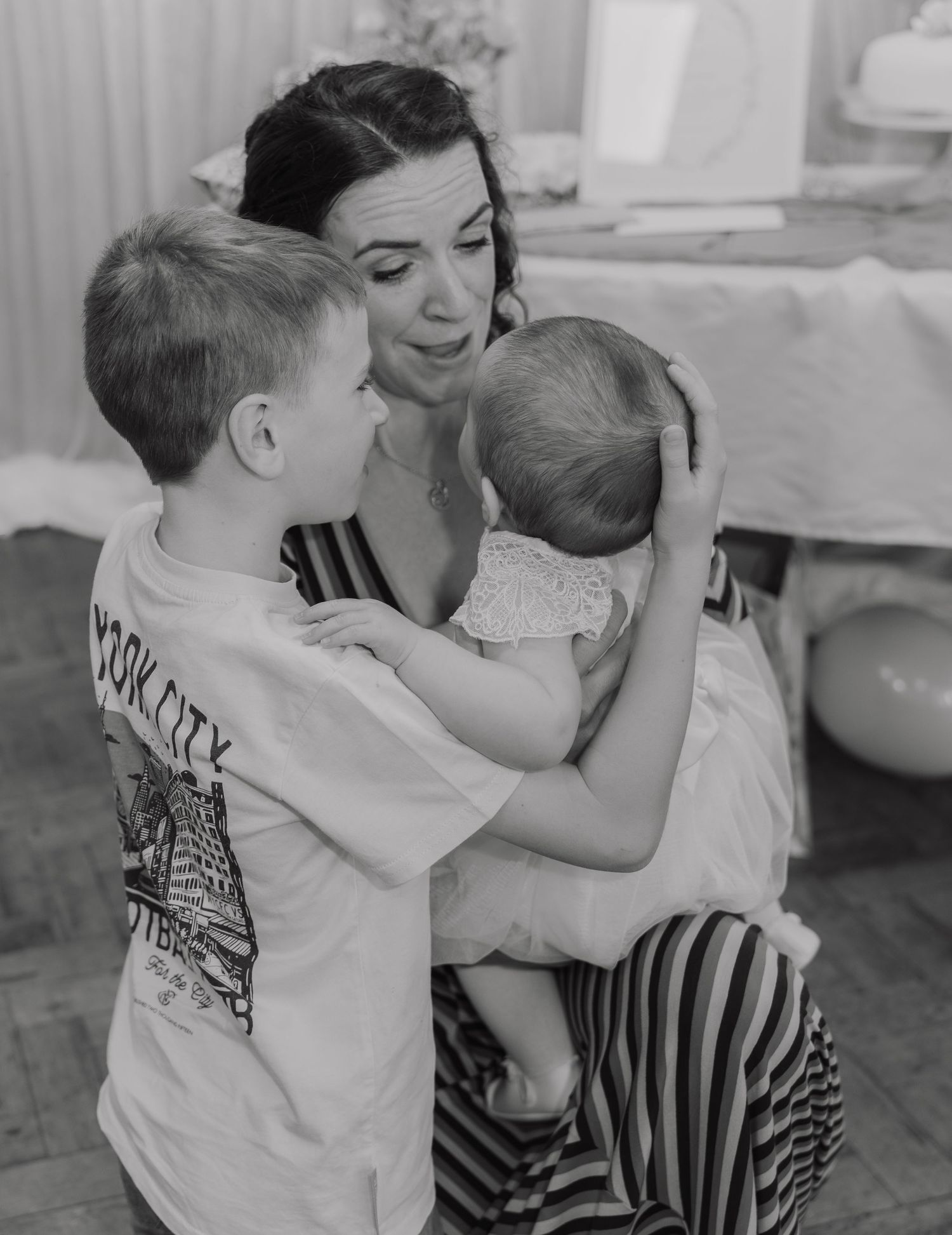 Black and white photo sequence showing a tender moment of affection and embrace between two people.