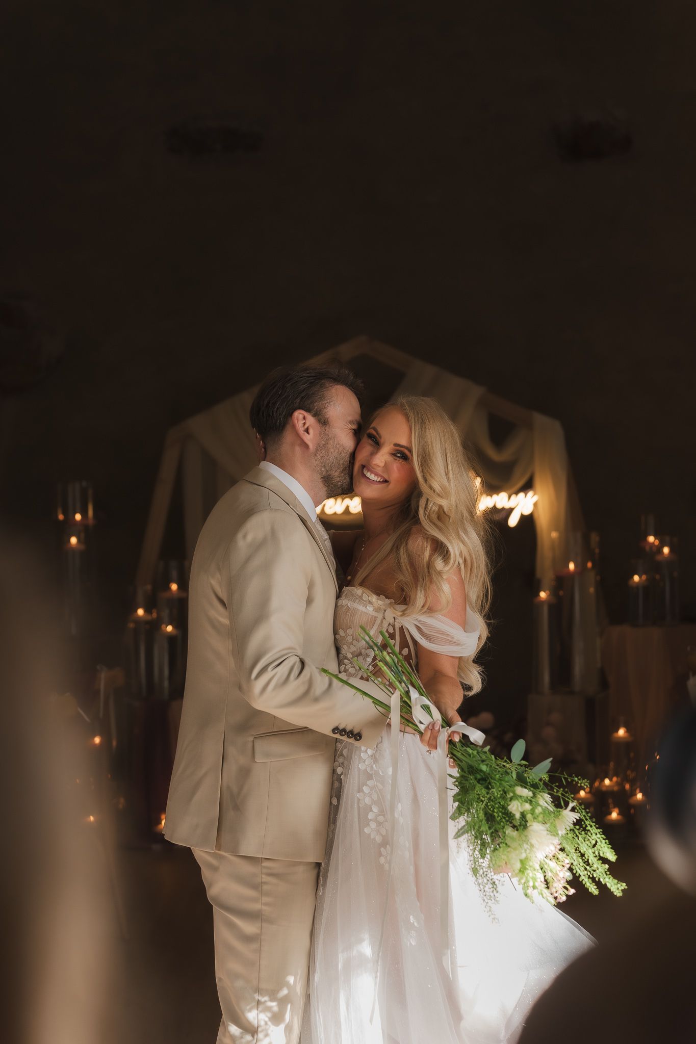 Romantic wedding couple dancing in a dimly lit venue with warm lighting and a dreamy atmosphere. Documentary Wedding Photography Derbyshire