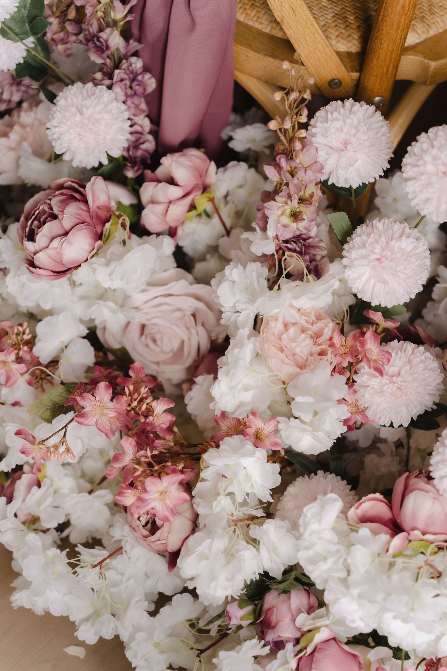 Close-up view of delicate pink and white cherry blossoms with soft petals arranged in a romantic floral display.
