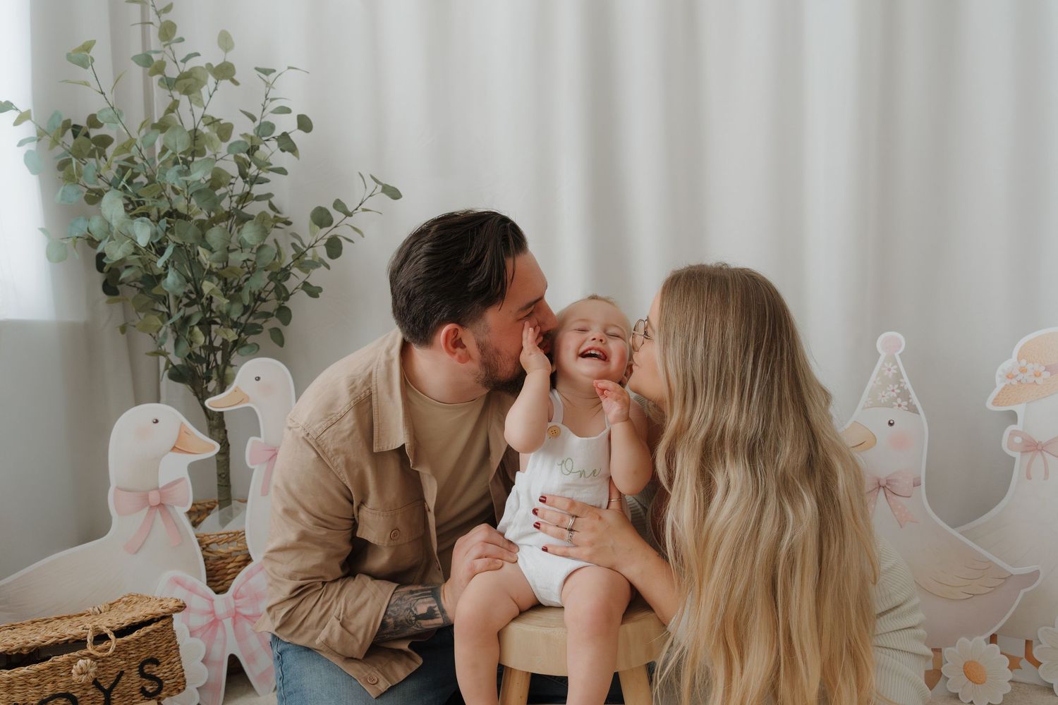 A family shares tender moments together in a series of soft, neutral-toned photographs.