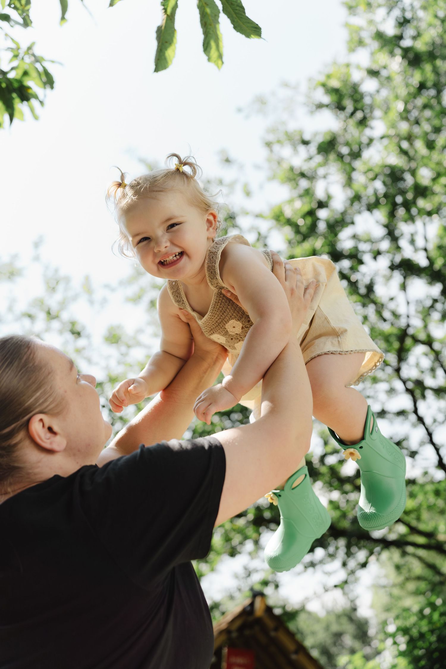 A joyful moment captured in a sequence of four photos showing playful interaction between adult and baby outdoors.