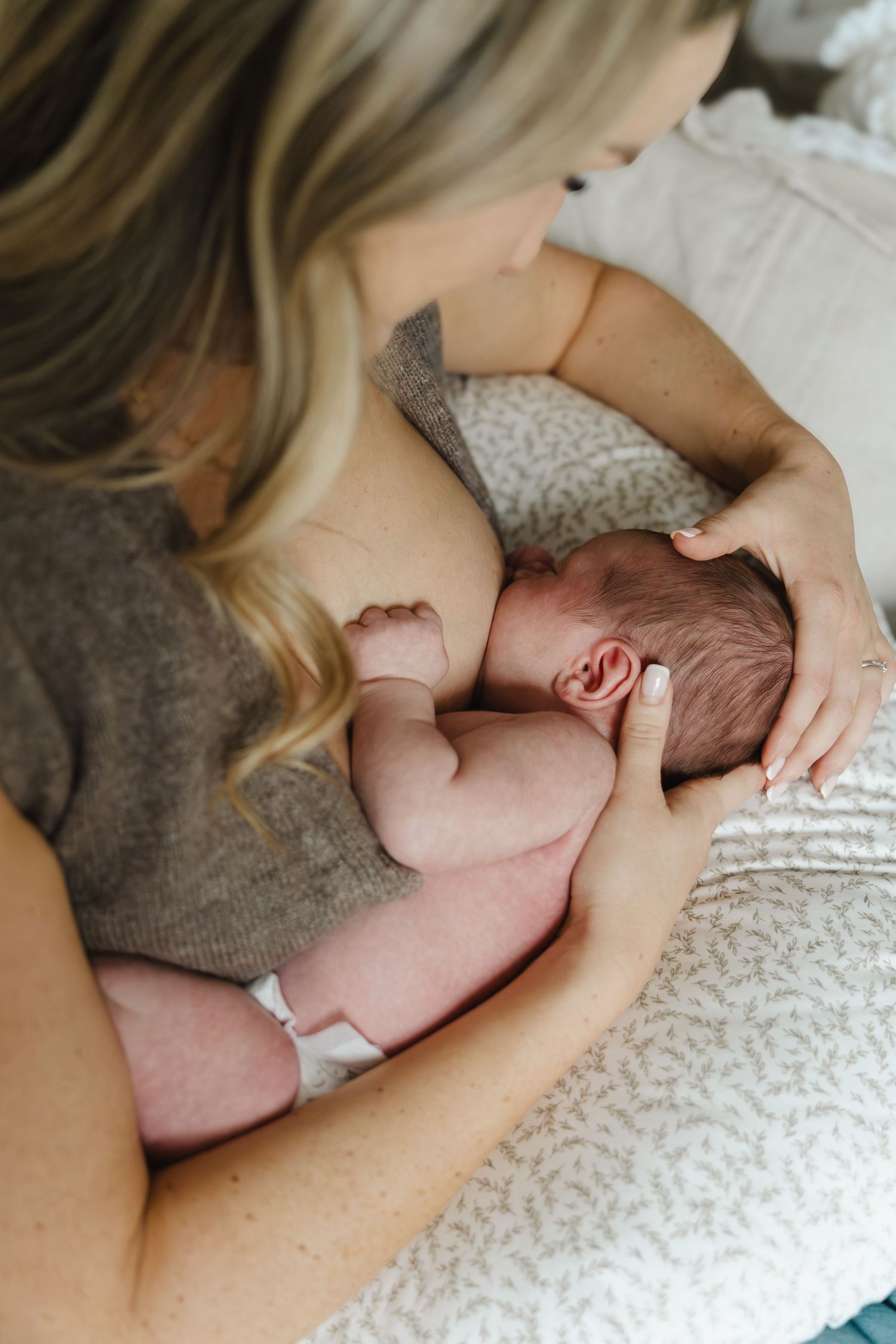 A tender moment captured in a series of photos showing a newborn baby being held and comforted on soft bedding.