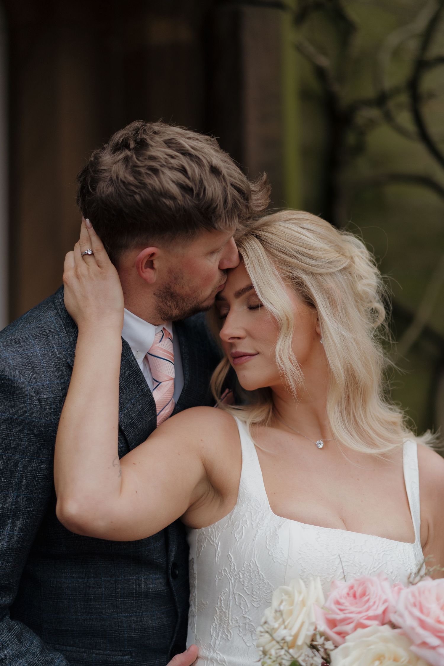 A romantic wedding photo series showing intimate moments between newlyweds against a natural outdoor backdrop. Documentary and editorial.