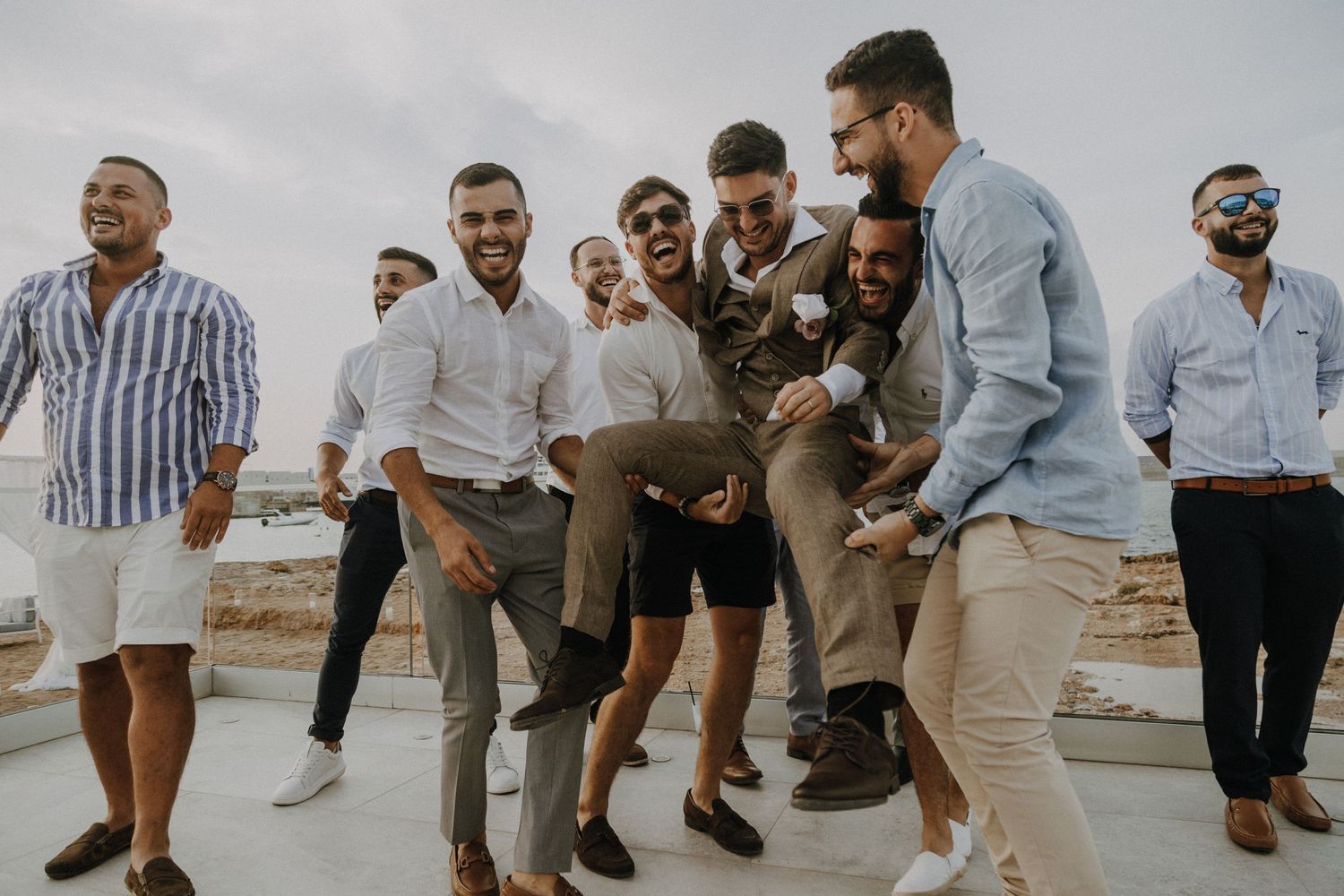 Celebratory group jump shot with people wearing coordinated blue and white outfits.