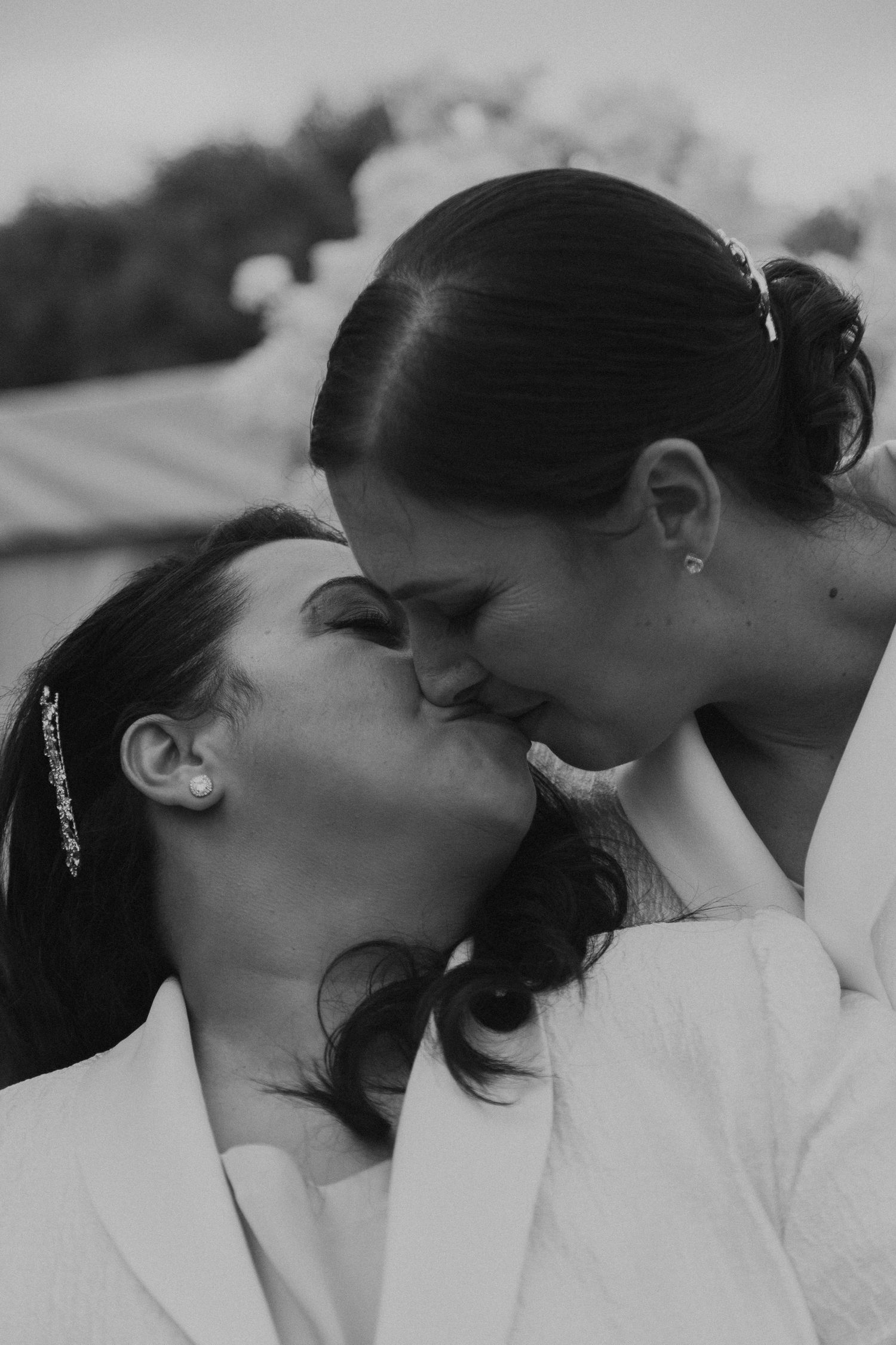 Black and white portrait of people in white attire at a formal event.