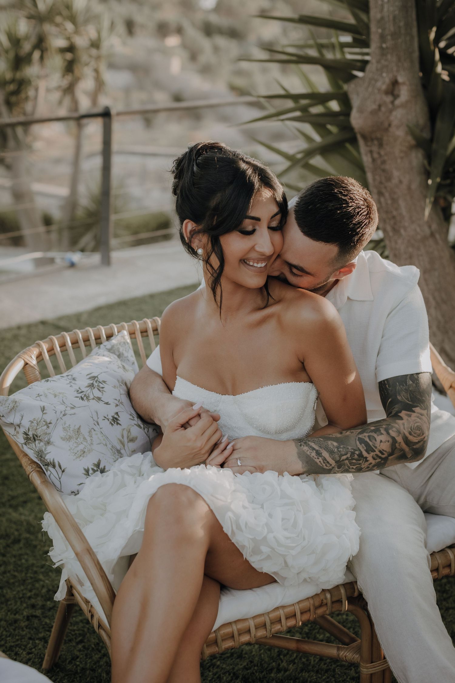 Intimate black and white wedding portraits on a rustic outdoor lounge chair.