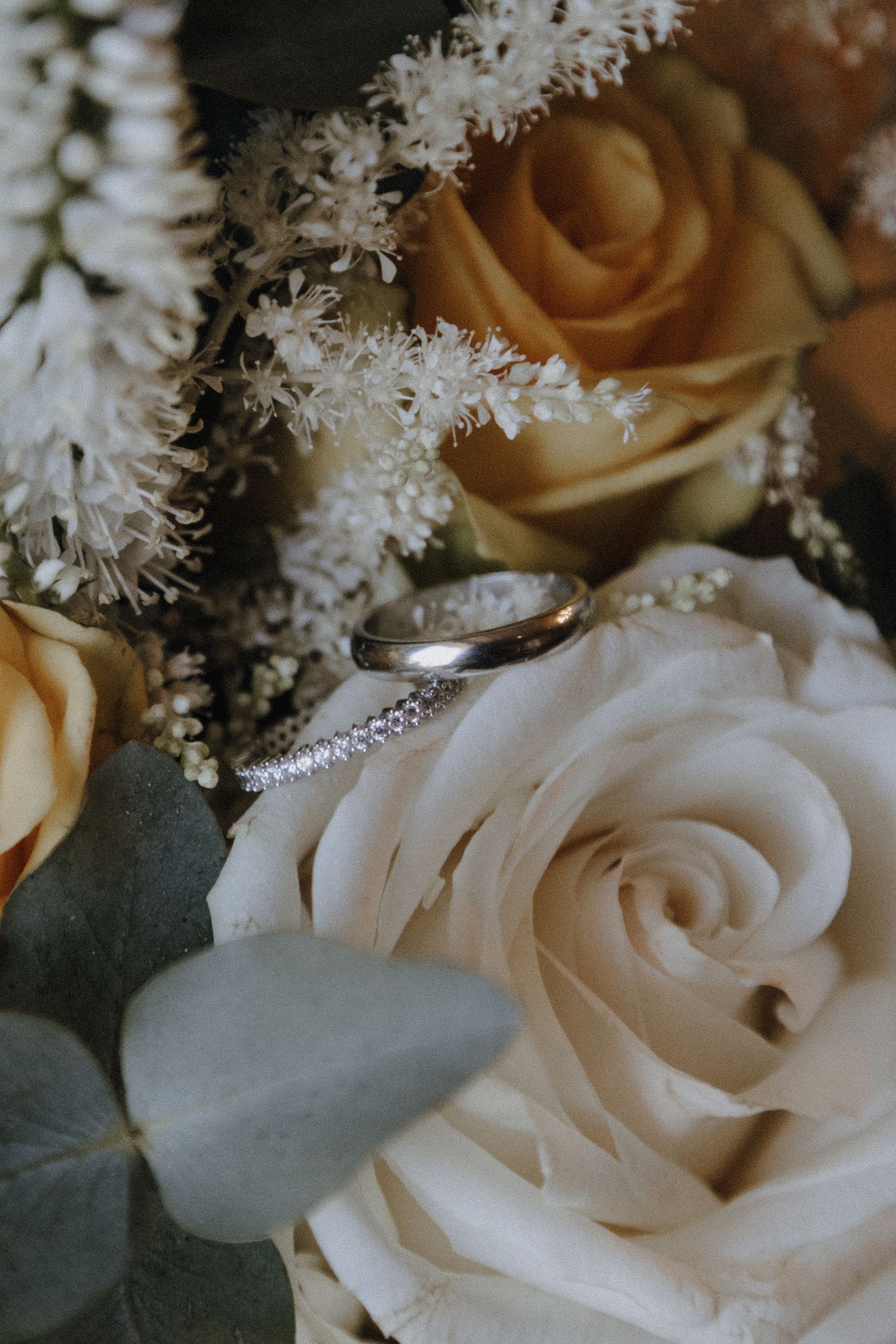 Close-up of delicate white roses and baby's breath flower arrangement.