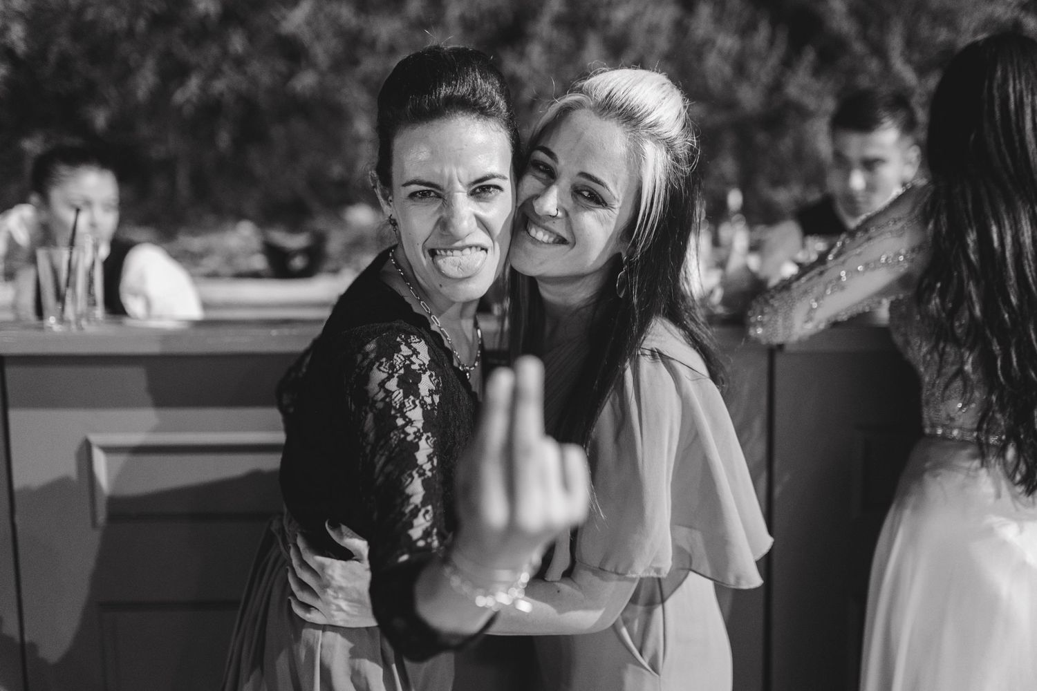 Black and white candid photos showing joyful moments during a wedding celebration.