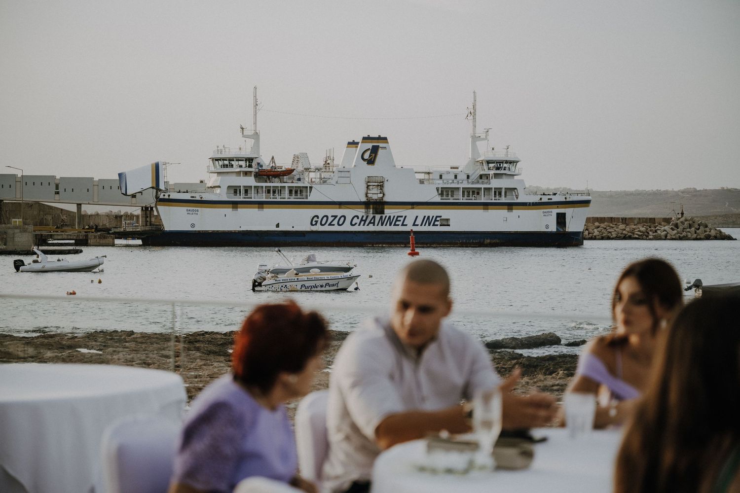 Ferry boat and watercraft visible in harbor during wedding celebration.