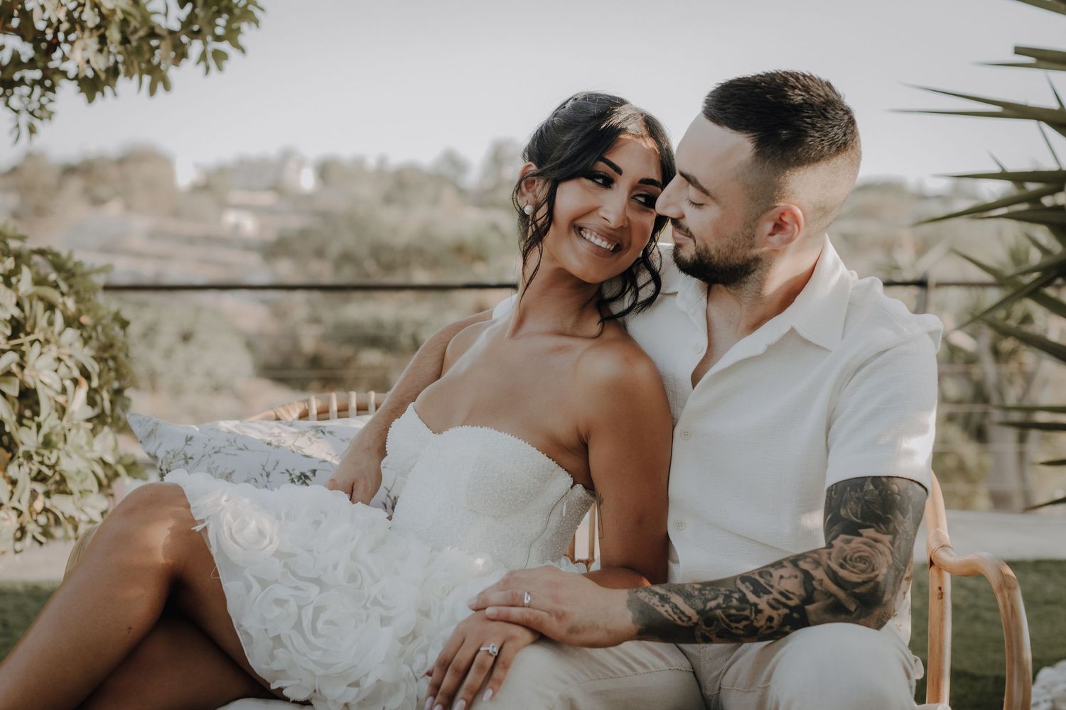 Newlyweds share tender embraces during their outdoor wedding photoshoot.