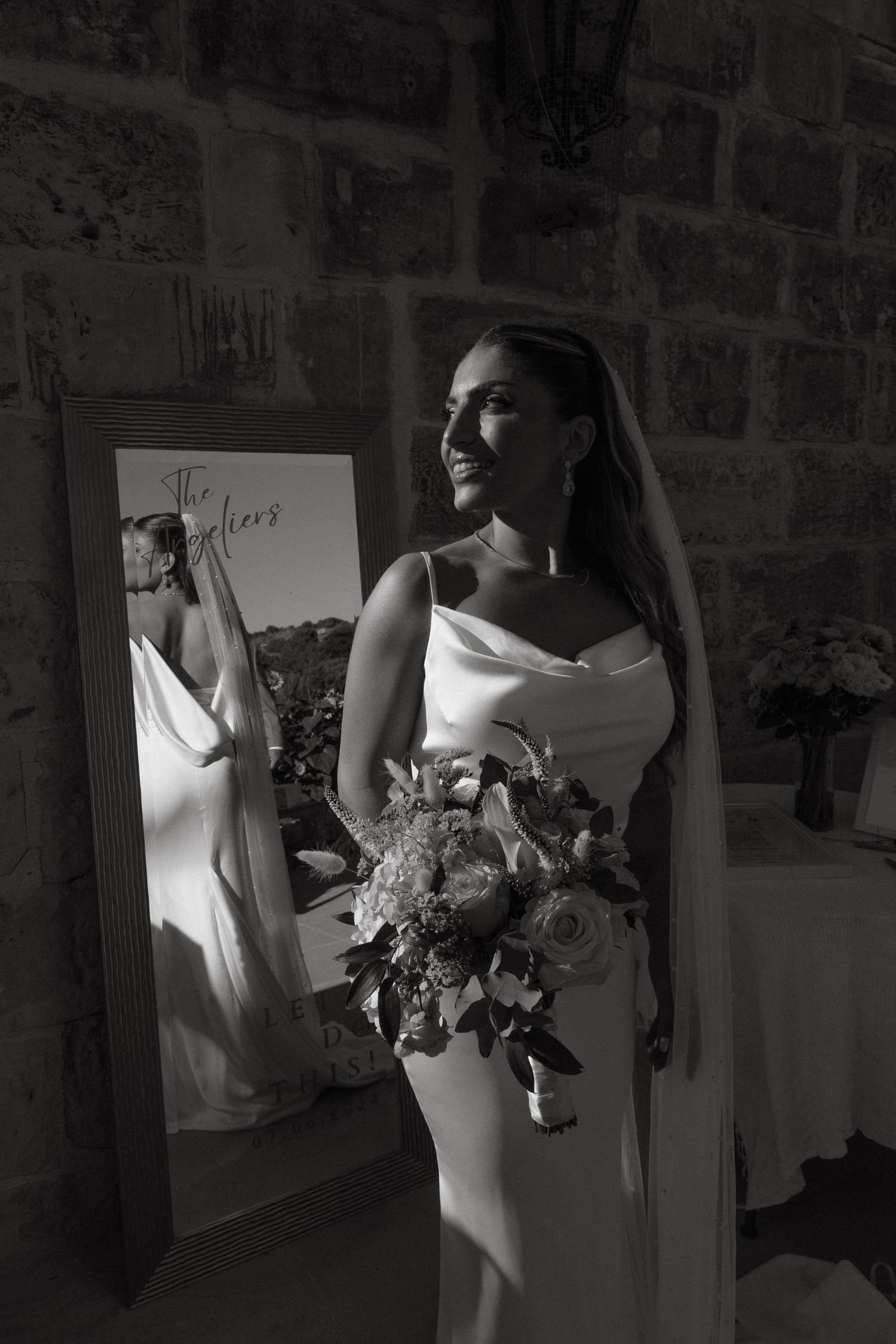 White wedding dress details with floral bouquet shown in elegant black and white composition.