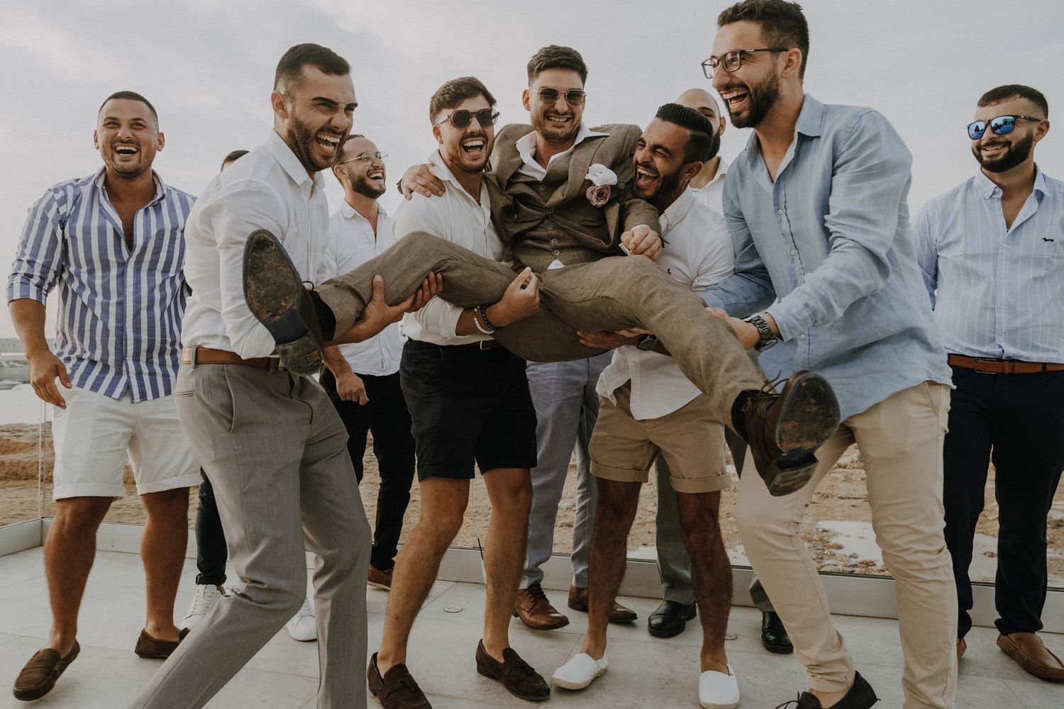 Dynamic group shot of people jumping and celebrating in casual summer attire.