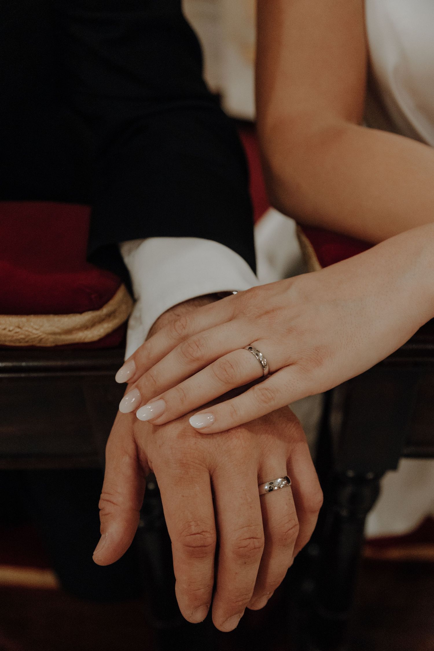 Close up of newlyweds' hands showing wedding rings.