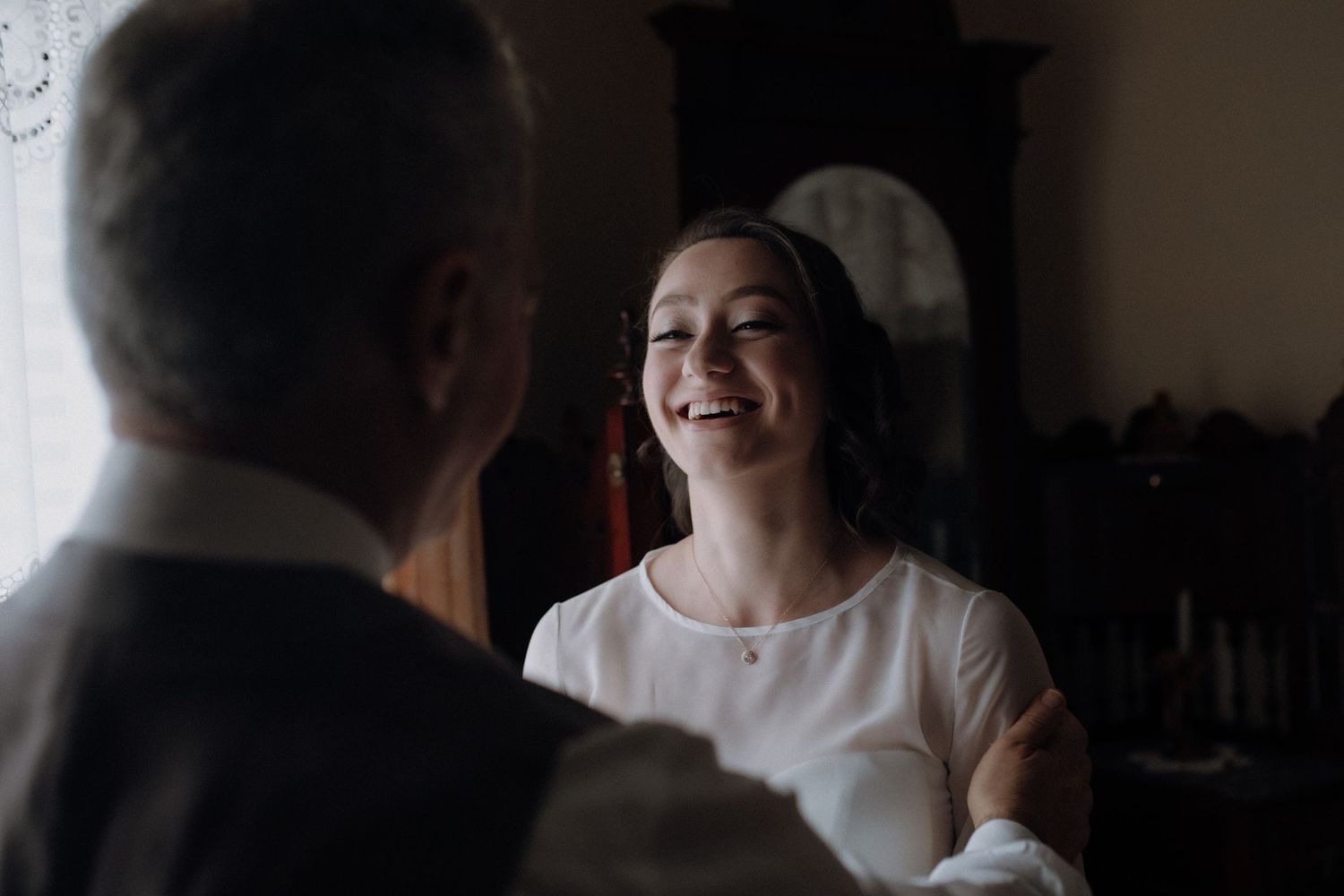 A radiant smile fills the frame during a tender moment of preparation.