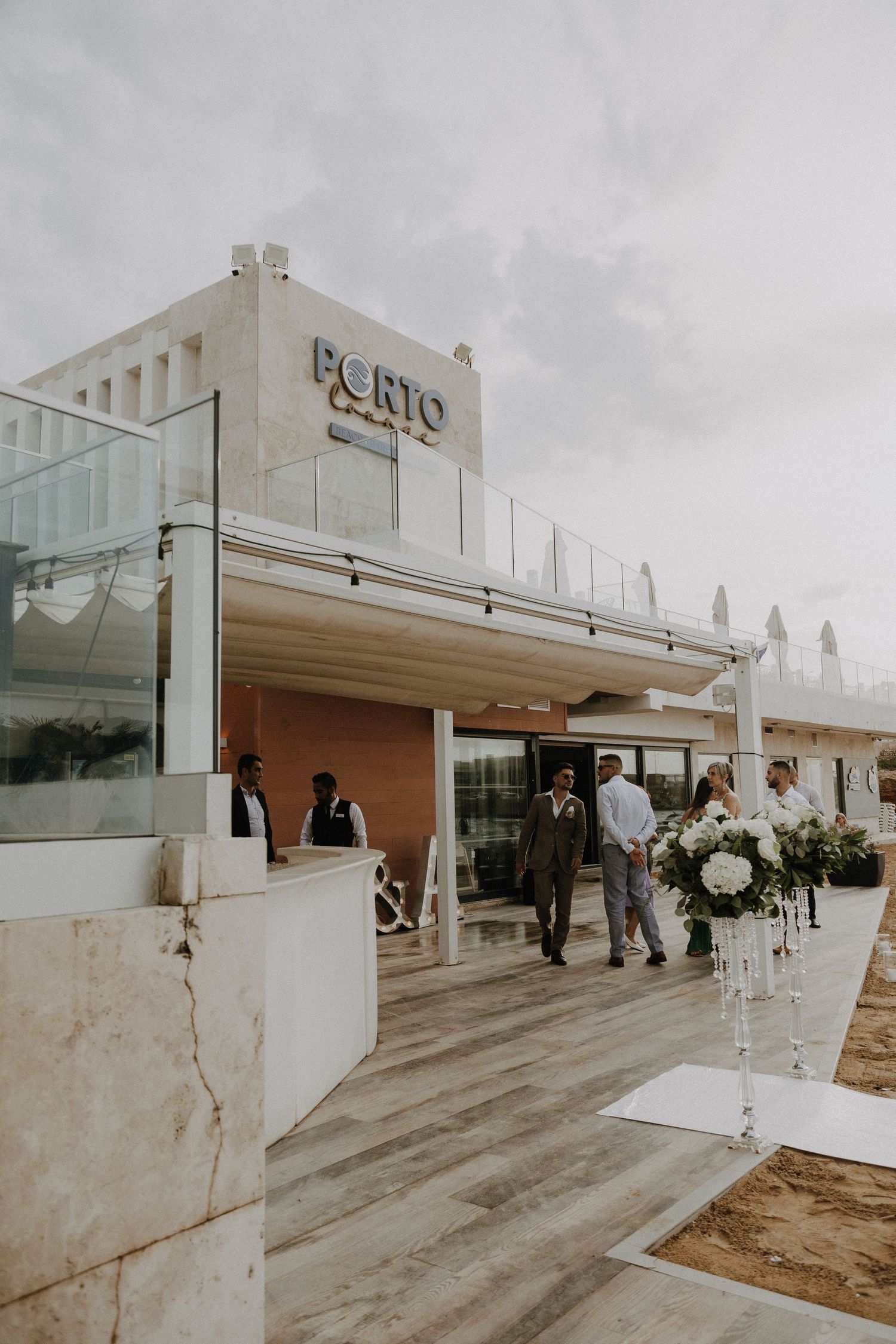 Porto restaurant exterior with modern white architecture and wedding decorations.