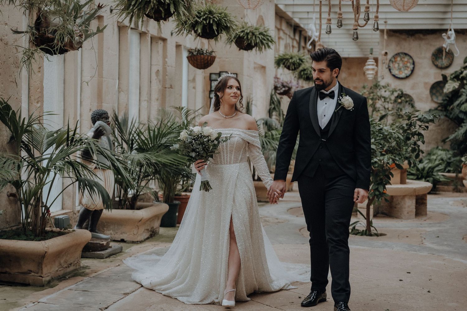 A romantic garden wedding scene with stone paths and lush green plants creating a natural backdrop.