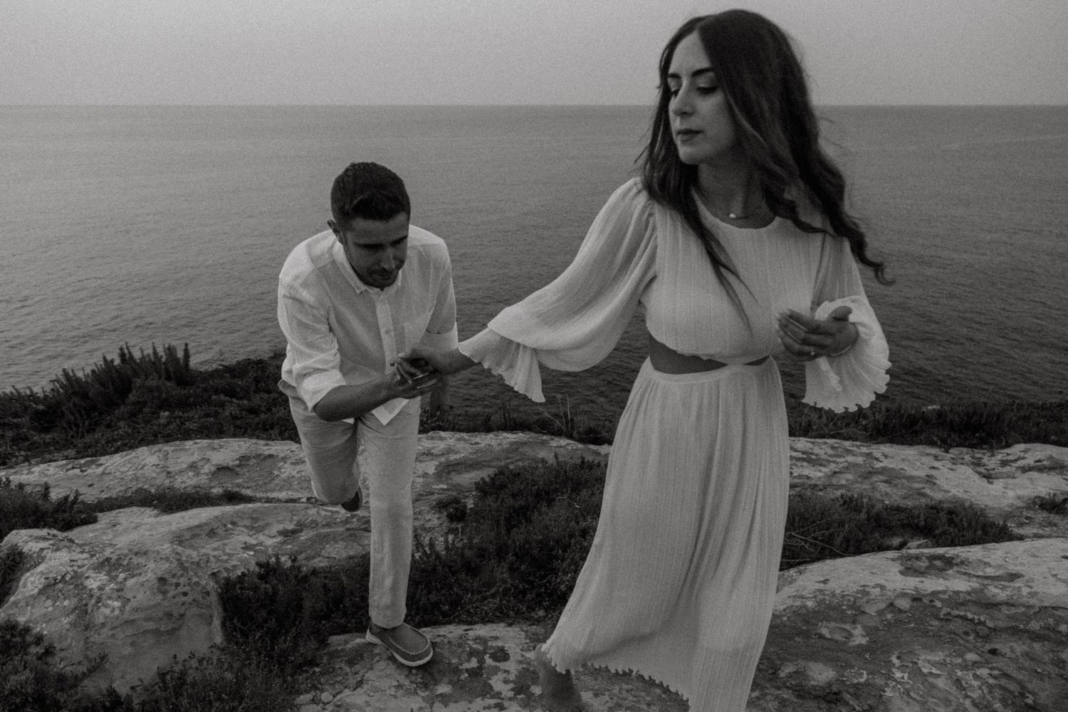 Artistic black and white photo of a couple during their coastal photoshoot.