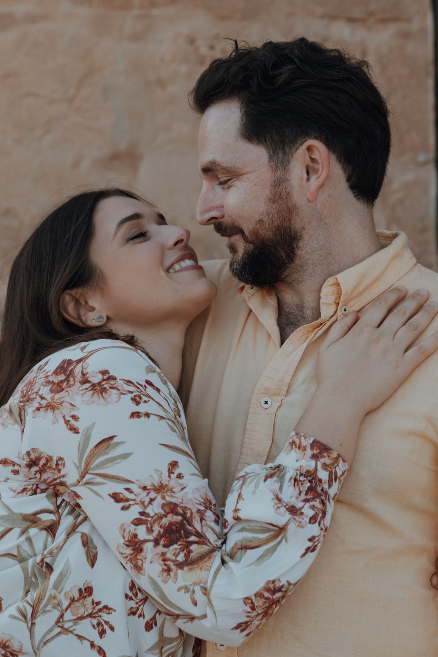 Romantic couple sharing intimate moments in a series of candid photos showing affection and laughter.