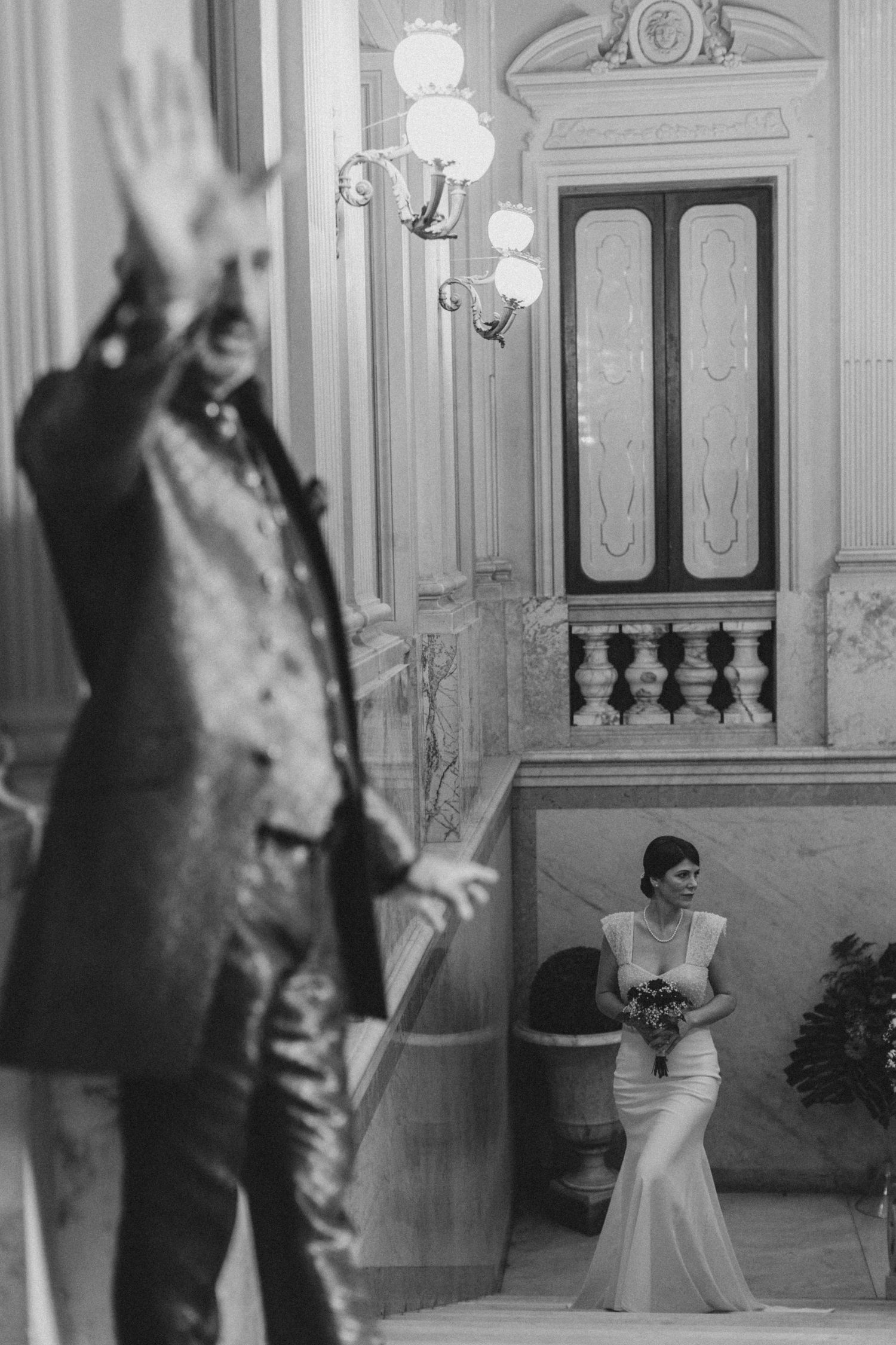 Black and white architectural interior with ornate statue and classical details.
