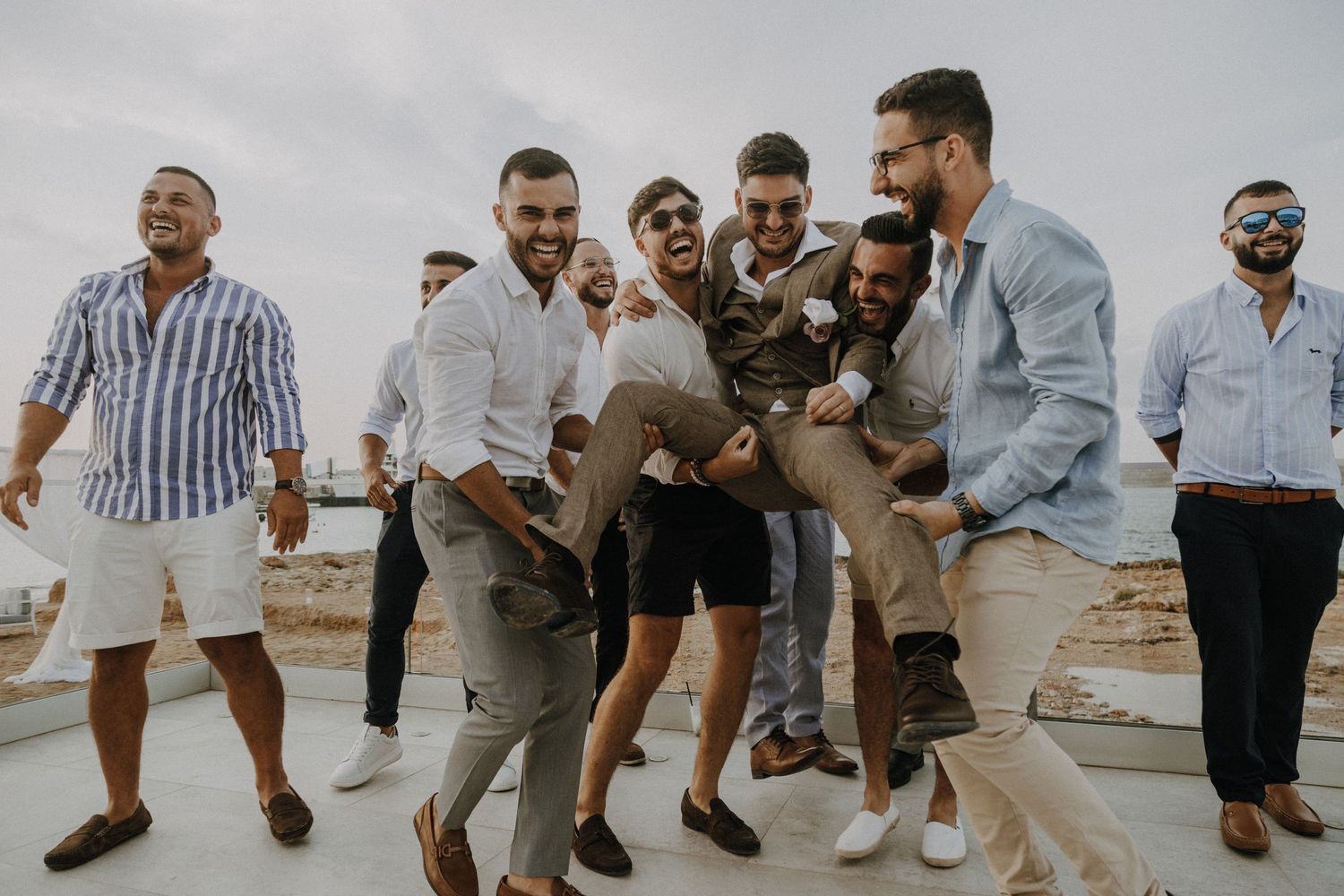 Friends in coordinated outfits performing synchronized jumps during an outdoor gathering.