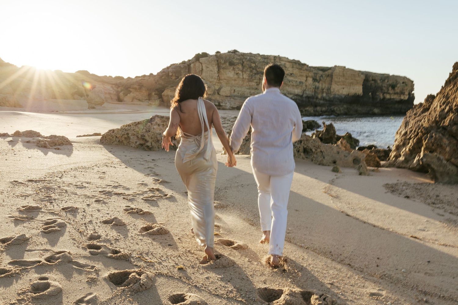 A couple running in Praia de São Rafael, in Albufeira, Portugal.