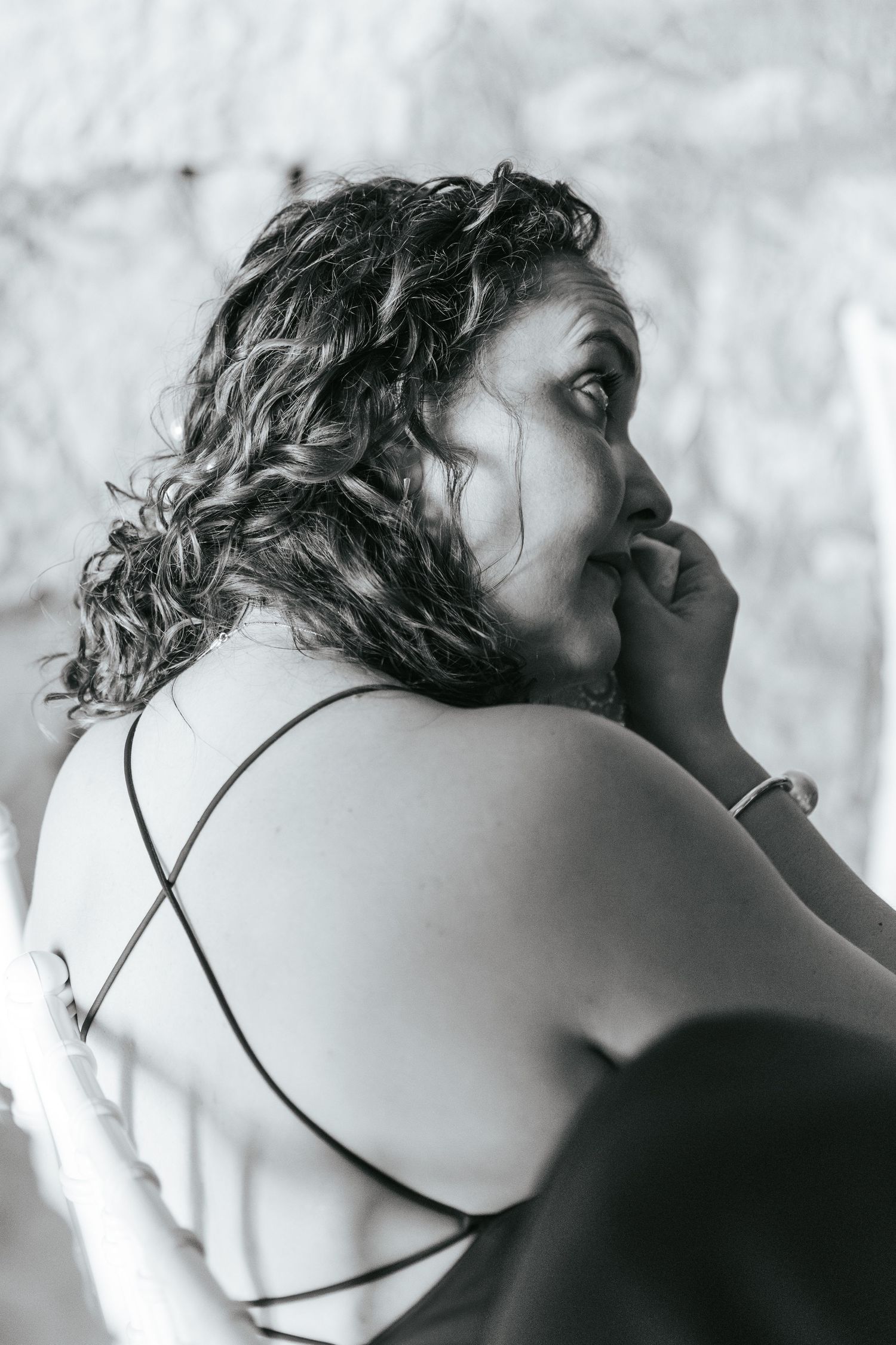 Close-up artistic black and white portrait showing delicate details of a bridal hairstyle.