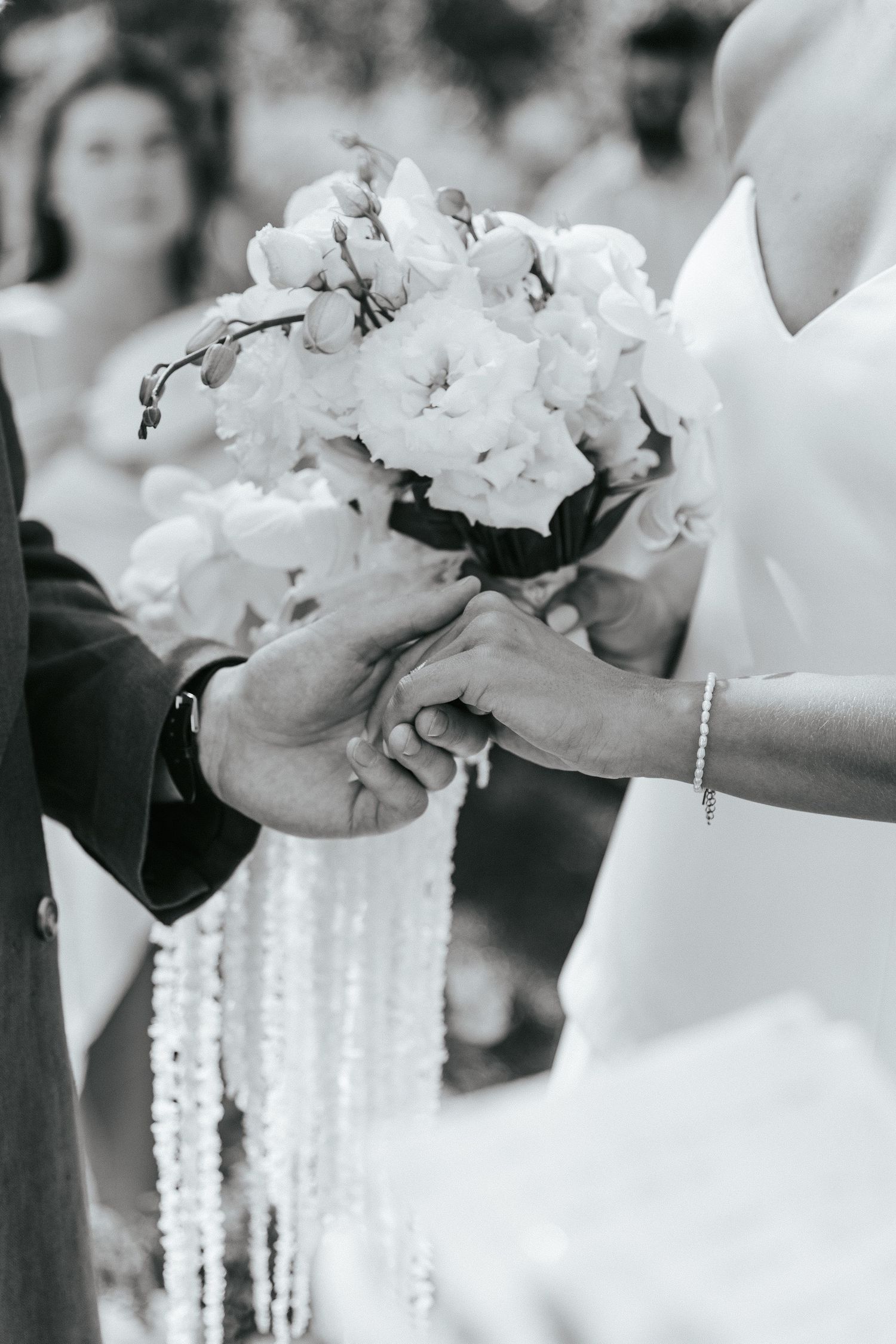 Black and white photo of bride and groom holdings hands in Morgado do Quintão venue, in Portugal.