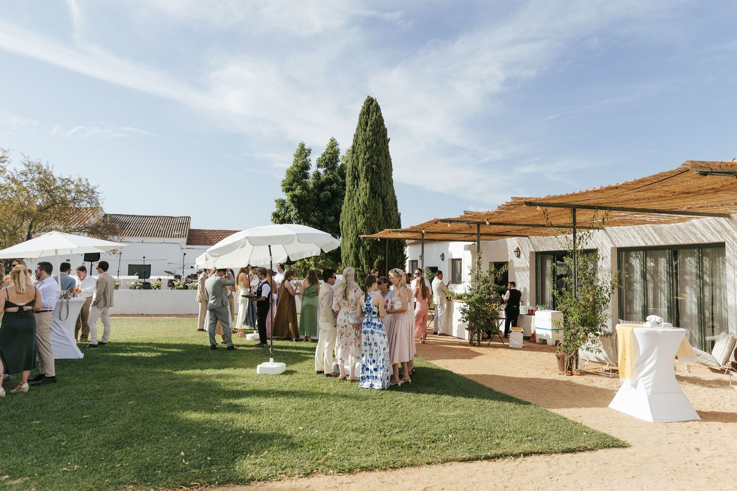 A collage of outdoor wedding venue scenes showing white tents, buildings, and grassy areas on a sunny day.