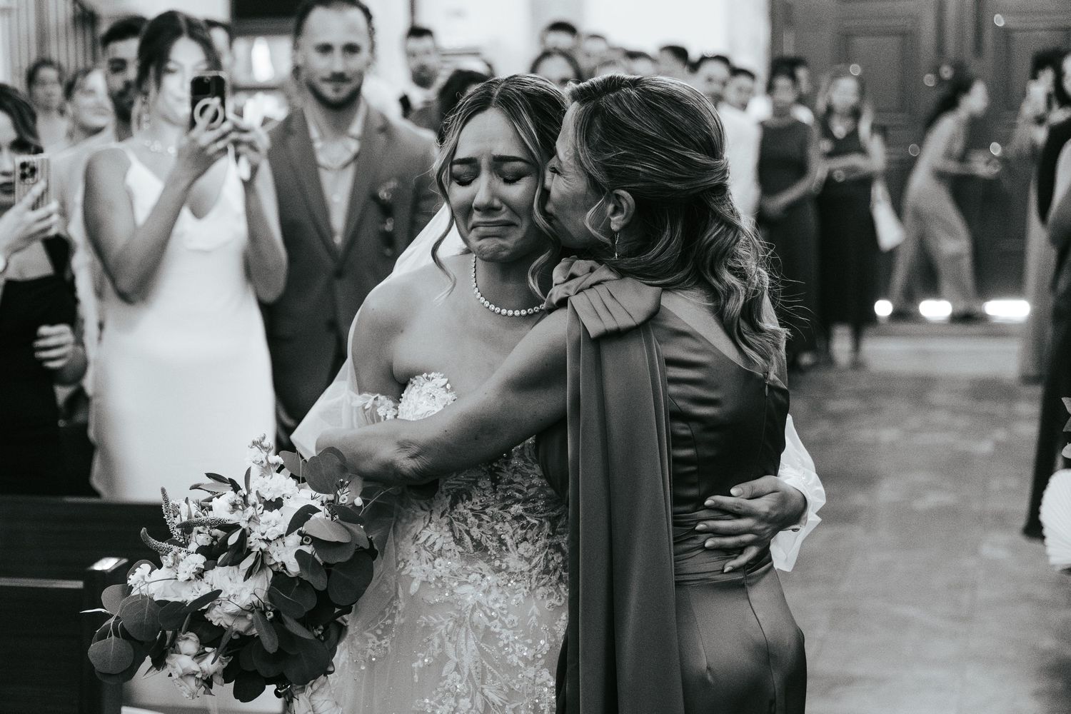 Black and white collage of candid wedding moments showing joyful celebrations and dancing at a reception.