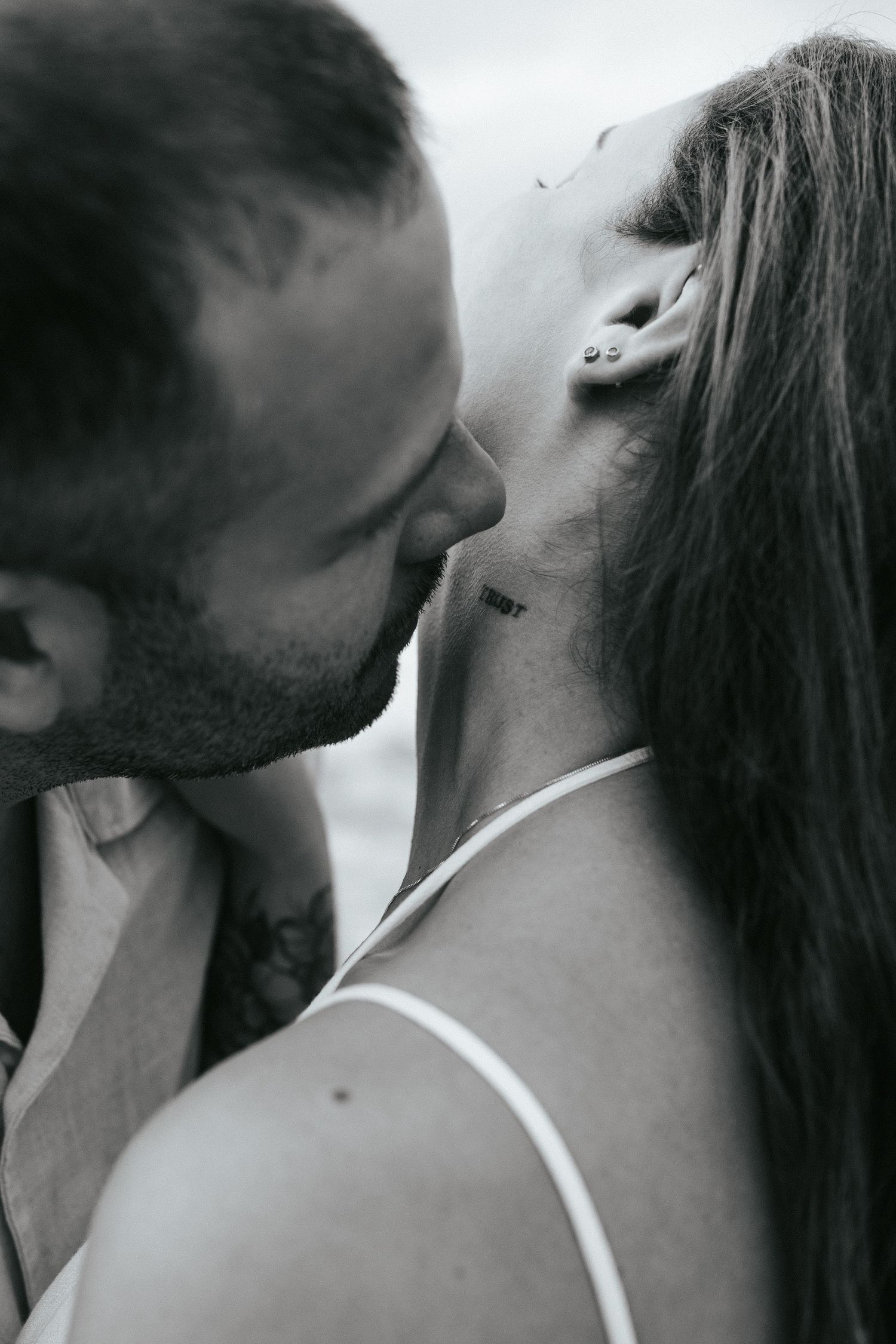 A series of black and white profile shots showing an intimate moment between two people in close proximity.
