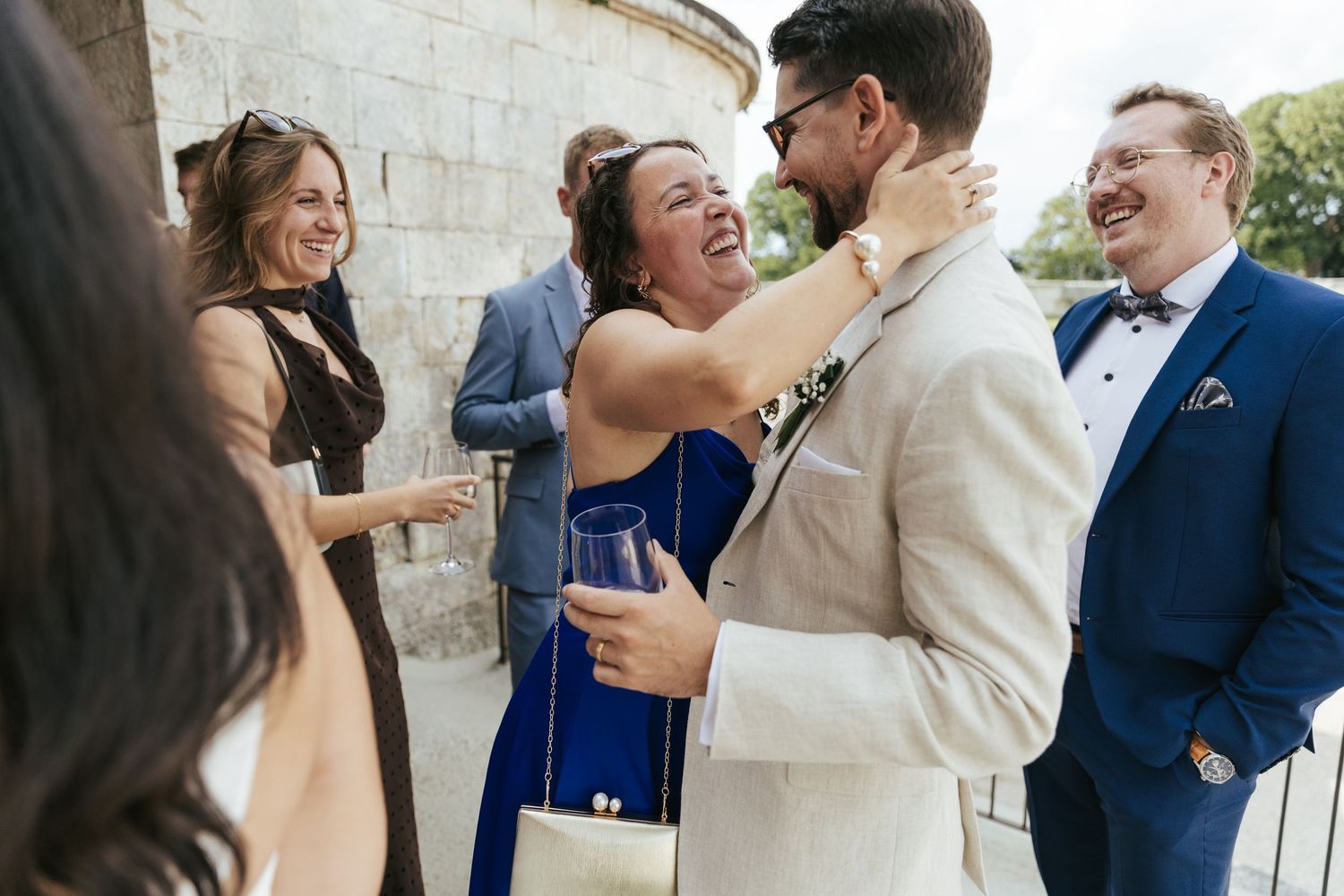 Joyful celebration moment among guests at outdoor gathering.