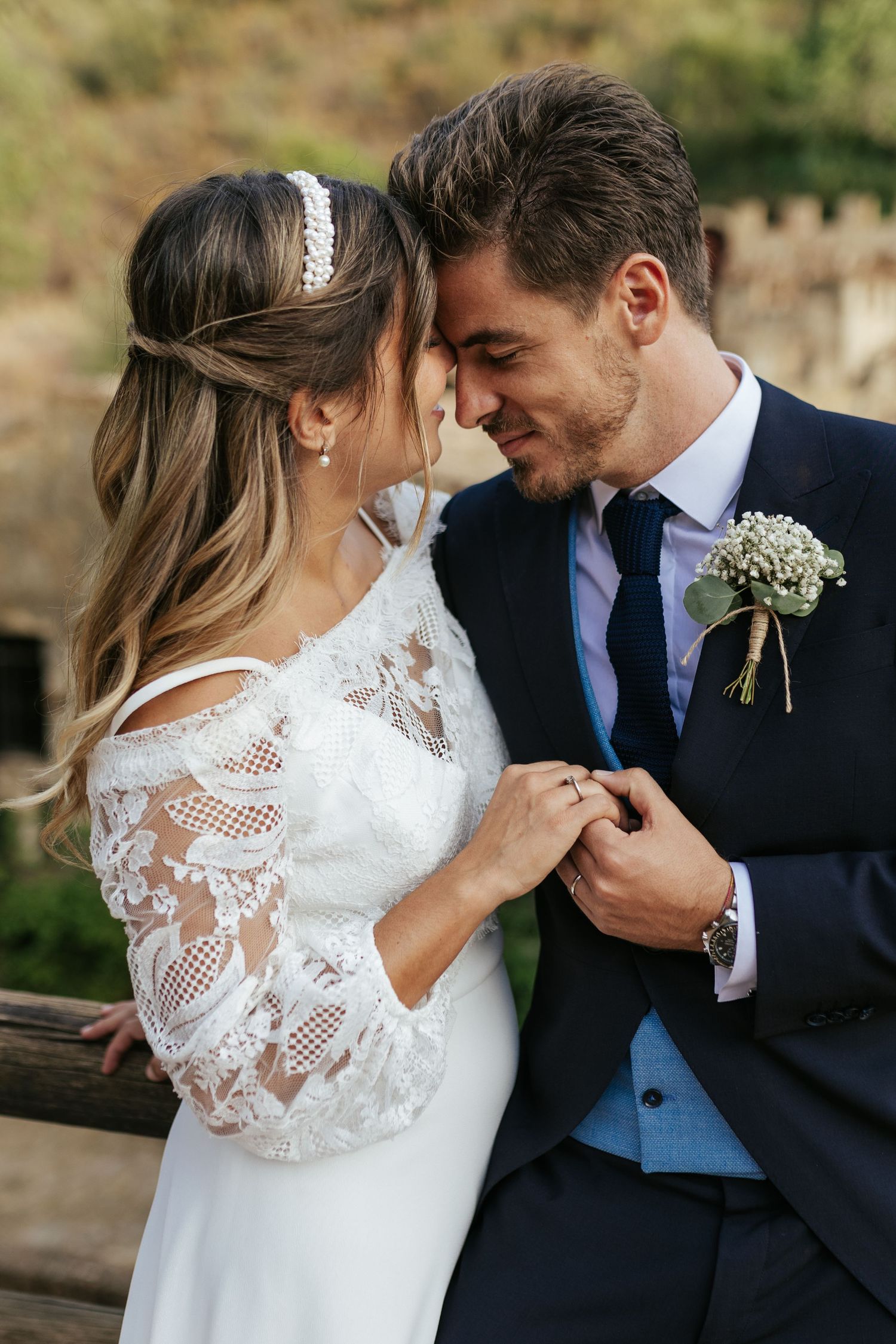 Romantic close-up of newlyweds in elegant wedding attire sharing an intimate moment.