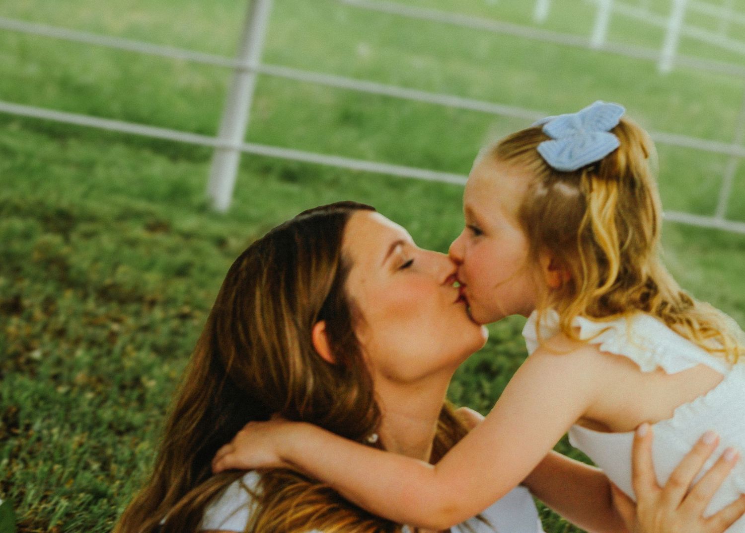 A sequence of joyful moments captured outdoors on a sunny day in a lush green field.
