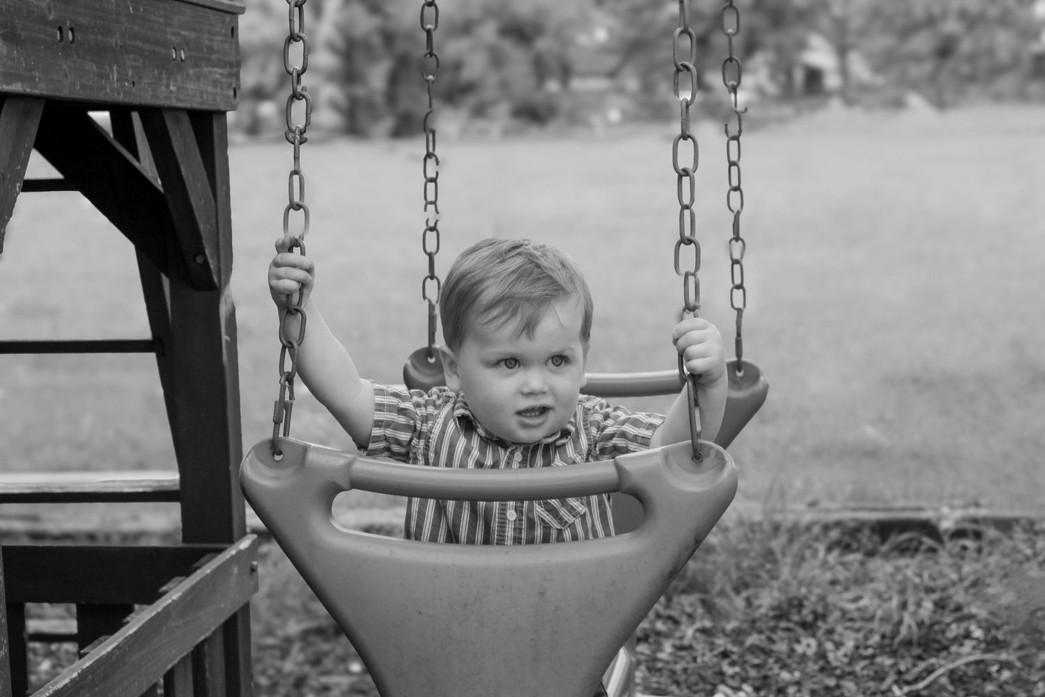 Black and white sequence showing playtime at a park swing set with children enjoying themselves.