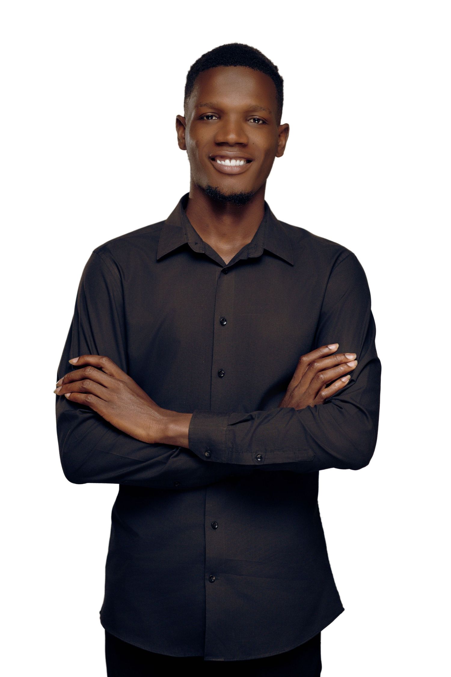 Person wearing dark button-down shirt poses with crossed arms and friendly expression against white background.