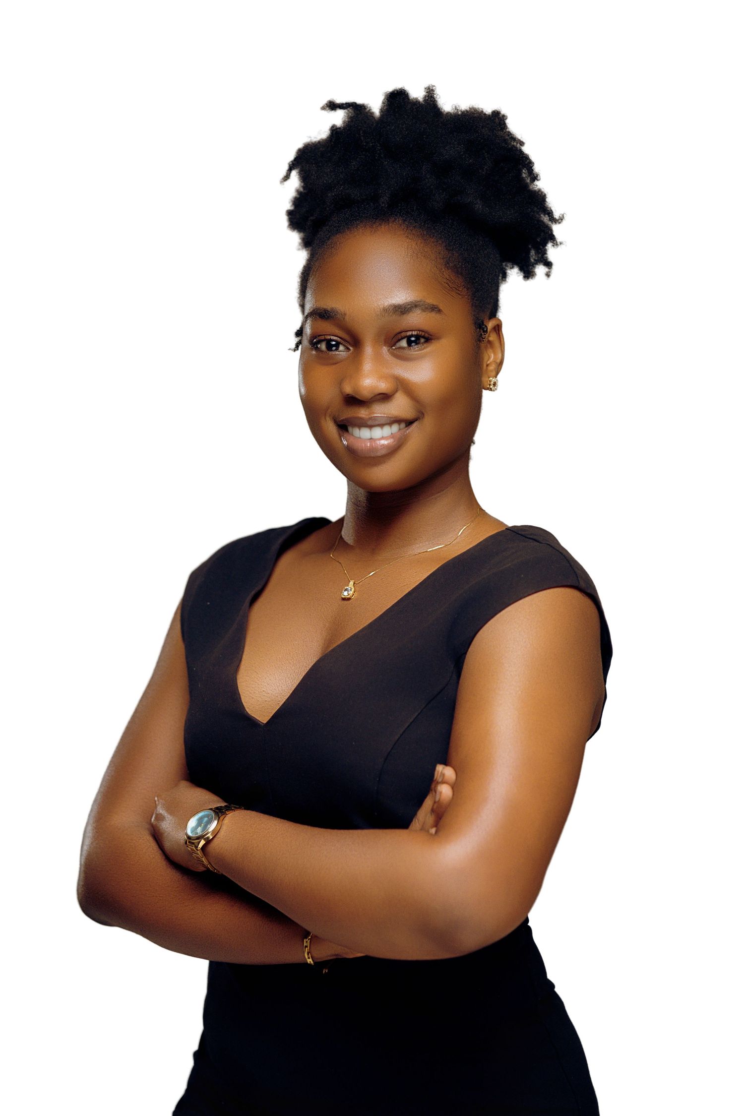 Person wearing black sleeveless top poses with arms crossed in professional photography studio portraits.