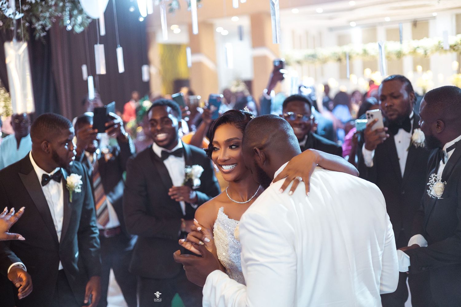 Candid moment of wedding celebration with guests in formal attire.