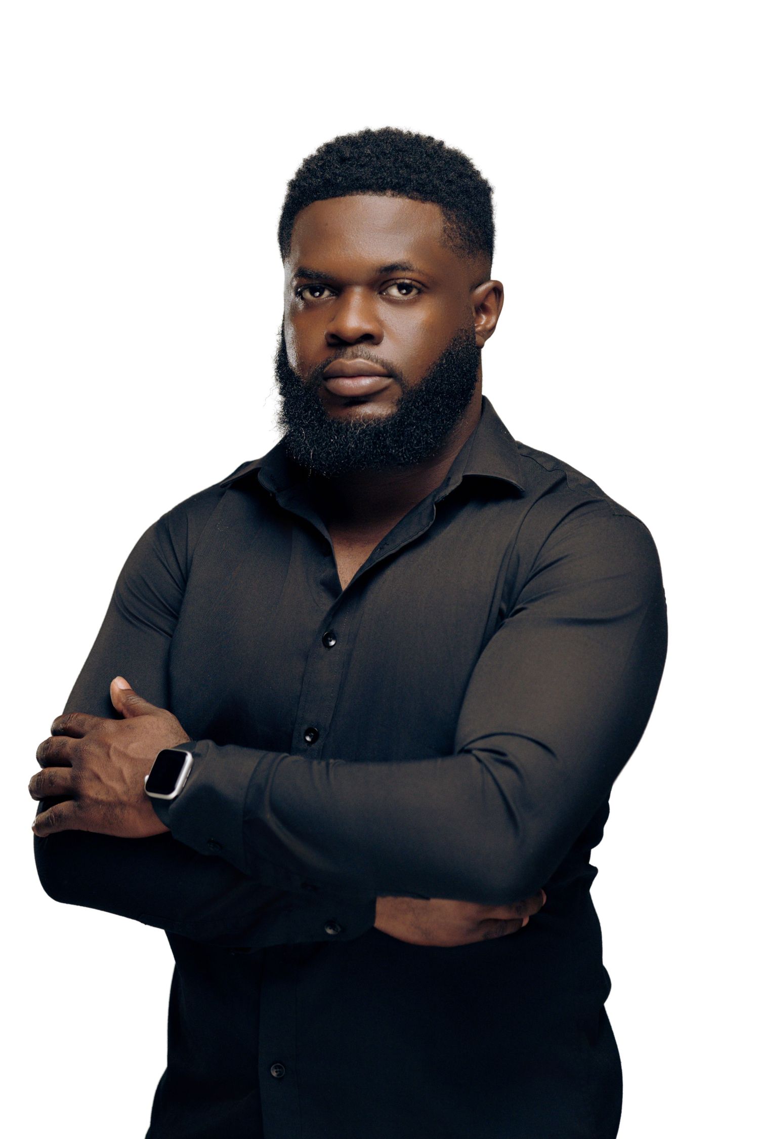 A person in a black button-down shirt poses confidently against a light background.
