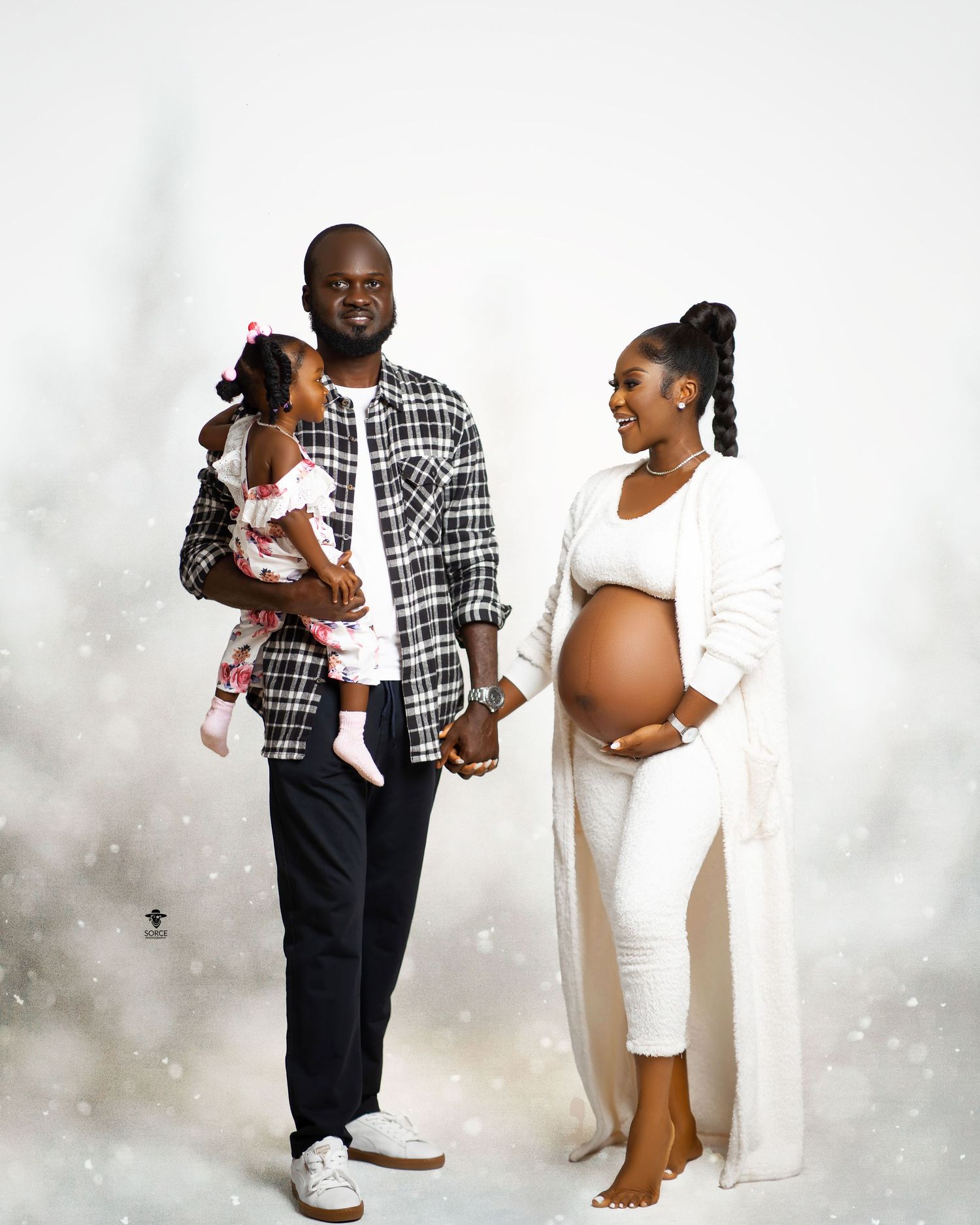 A series of maternity photos showing a couple in black and white attire posing together in various intimate poses.