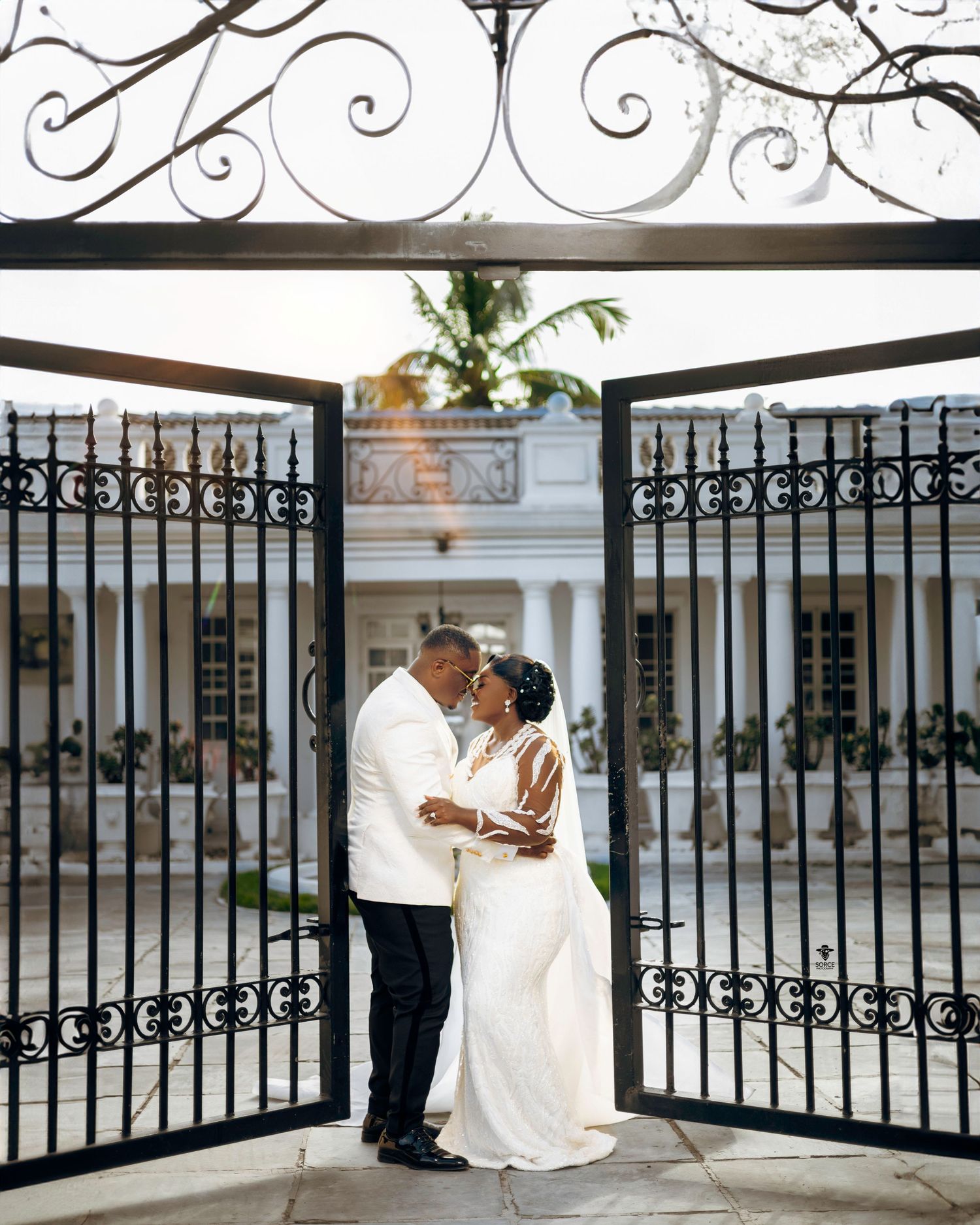 A composite of multiple wedding photos showing romantic poses against ornate iron gates and white architectural details.