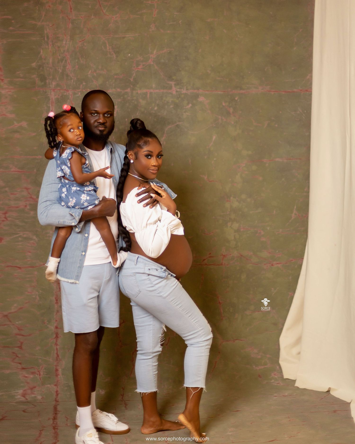 A sequence of four photos showing a group posing together against a concrete wall in matching light-colored outfits.
