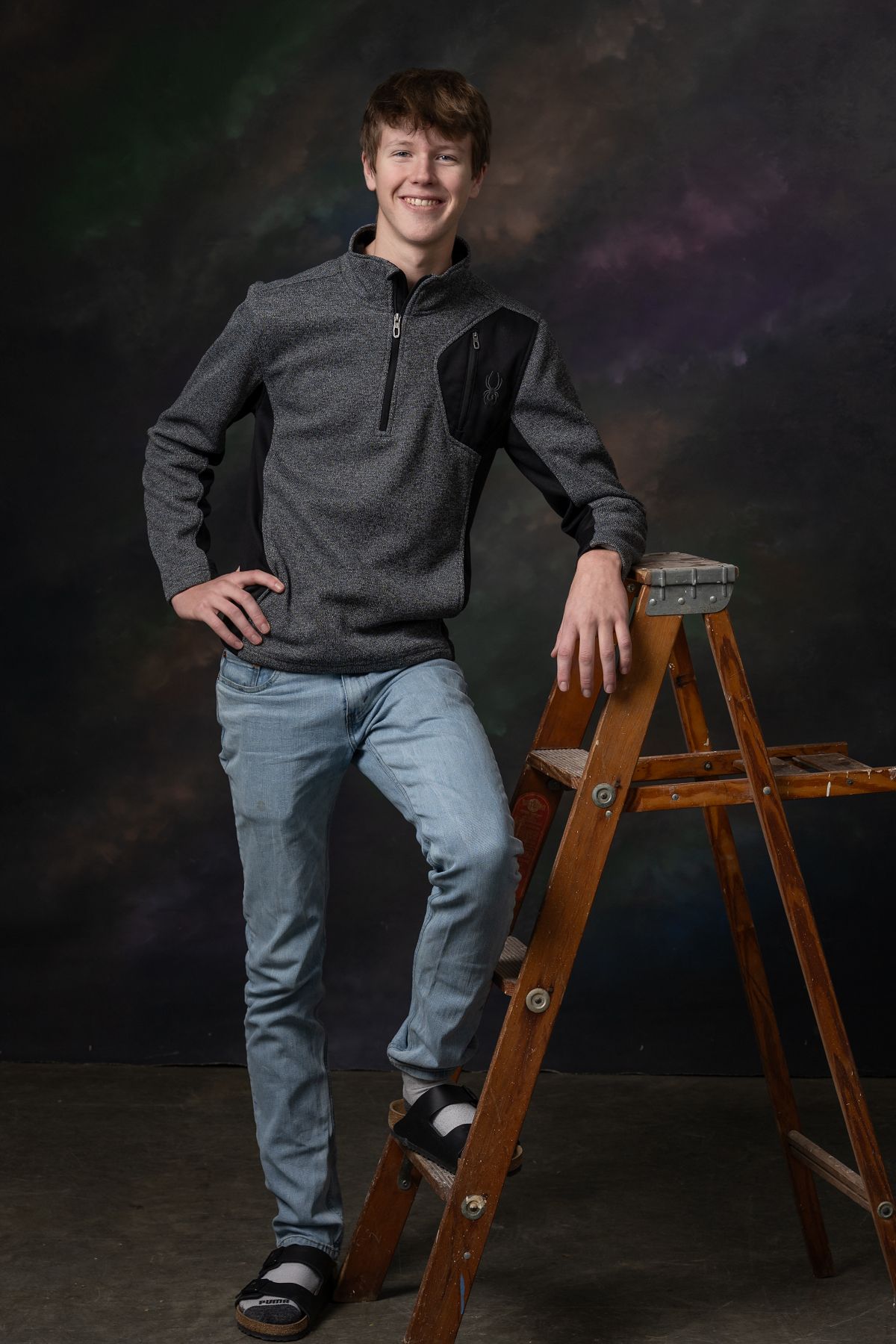 Senior portrait of a young man with a rustic ladder, studio backdrop, Chris Cleveland Photography, Fulton, MO.