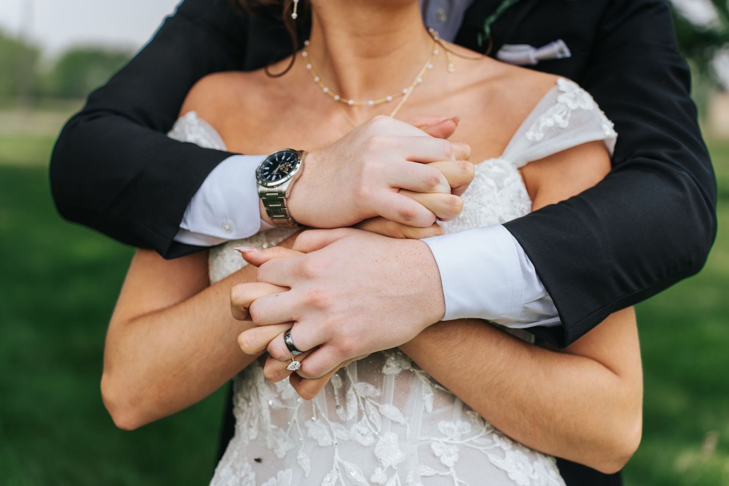 Close-up shots of a couple embracing and holding hands during a wedding photoshoot in an outdoor garden setting.