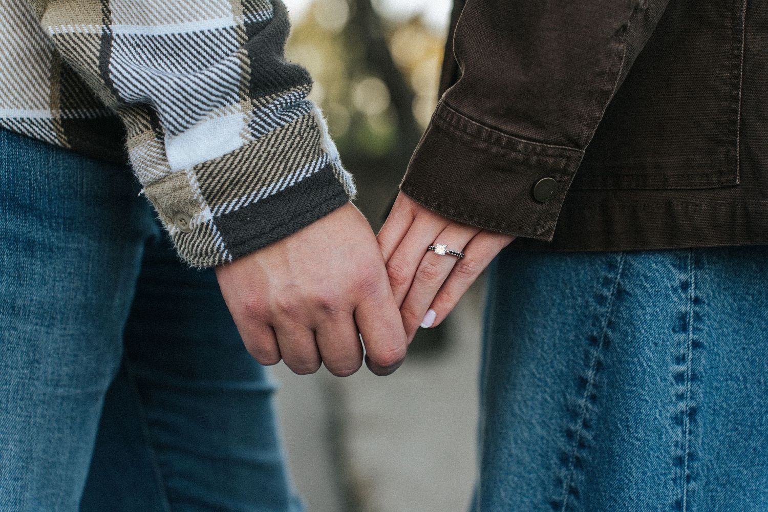 Close-up view of rolled up blue denim jeans with cuffed hems showing textured fabric detail.