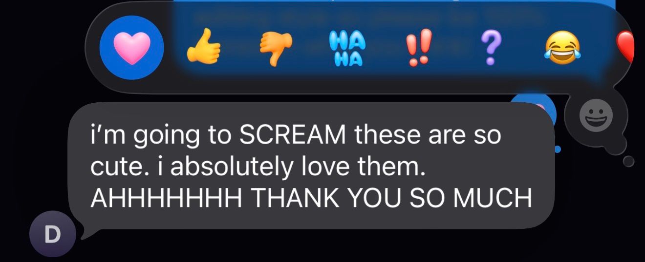 Screenshot of an enthusiastic Facebook message reaction expressing excitement and gratitude with emoji reactions above.