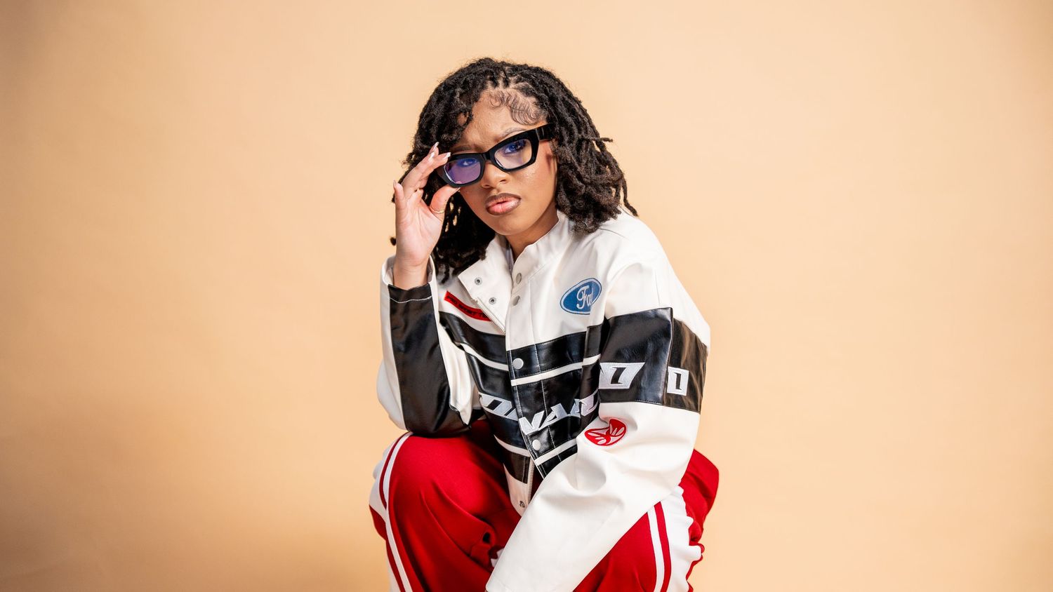 Studio portraits against a beige background showing playful poses and expressions.
