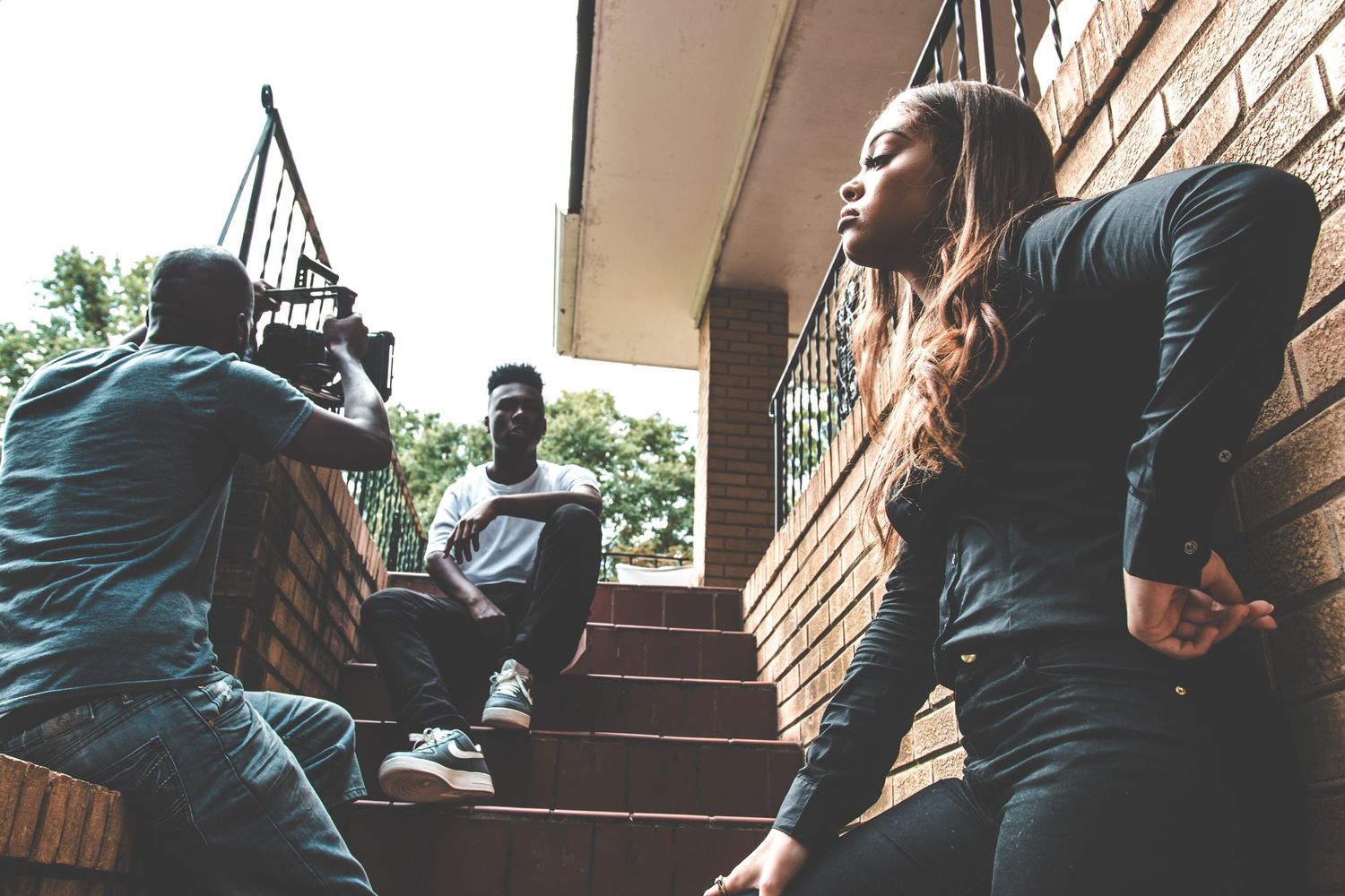 A series of candid shots showing a couple sitting together on outdoor stone steps.