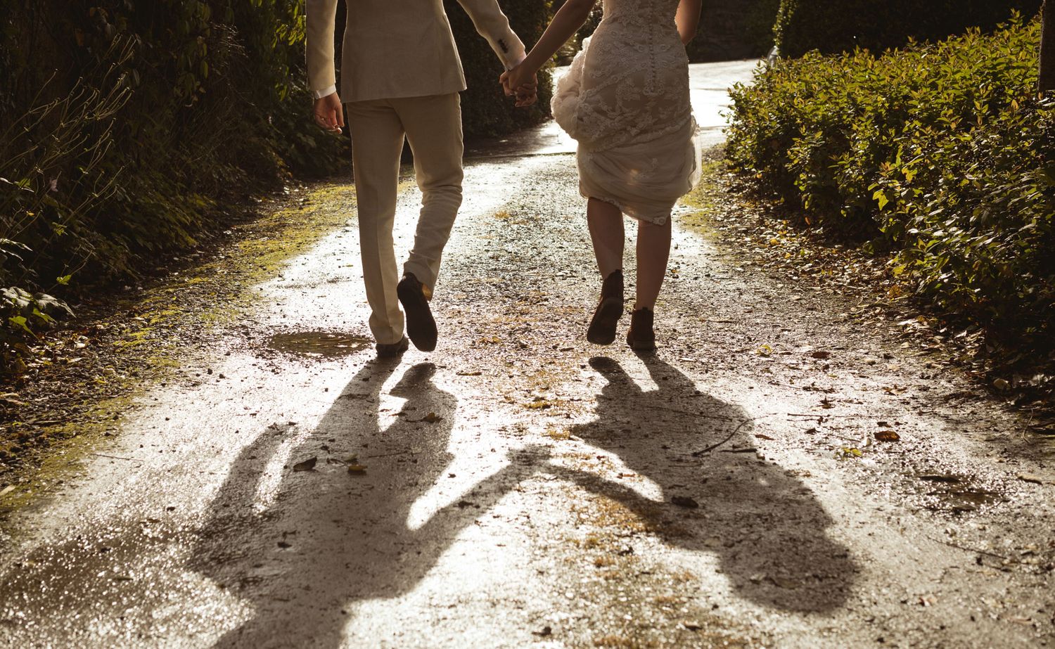 Bride and groom strolling along path at Kinsale wedding photographed by wedding photographer Paul Cowhig